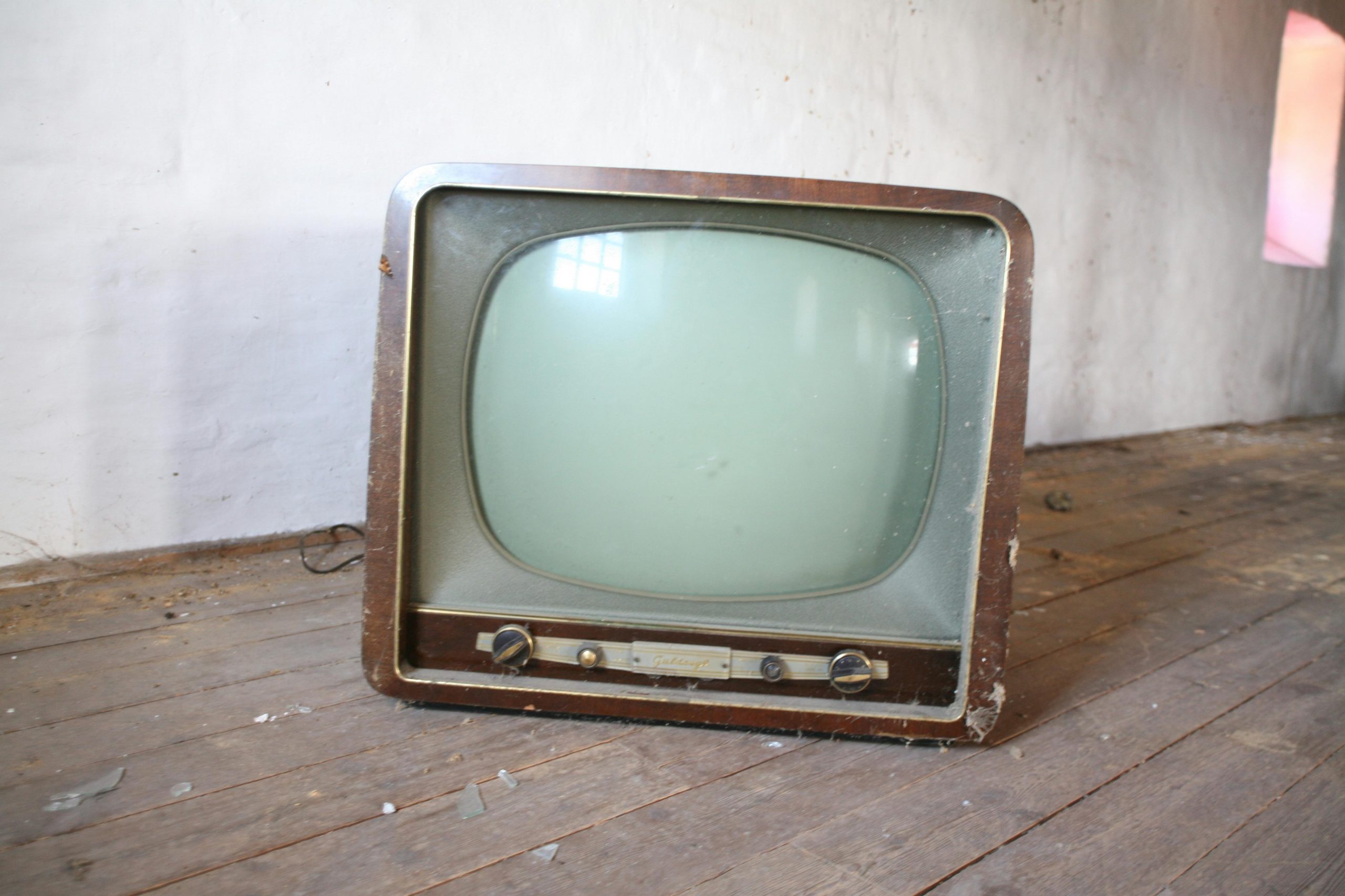 vintage-brown-crt-tv-on-parquet-wood-flooring
