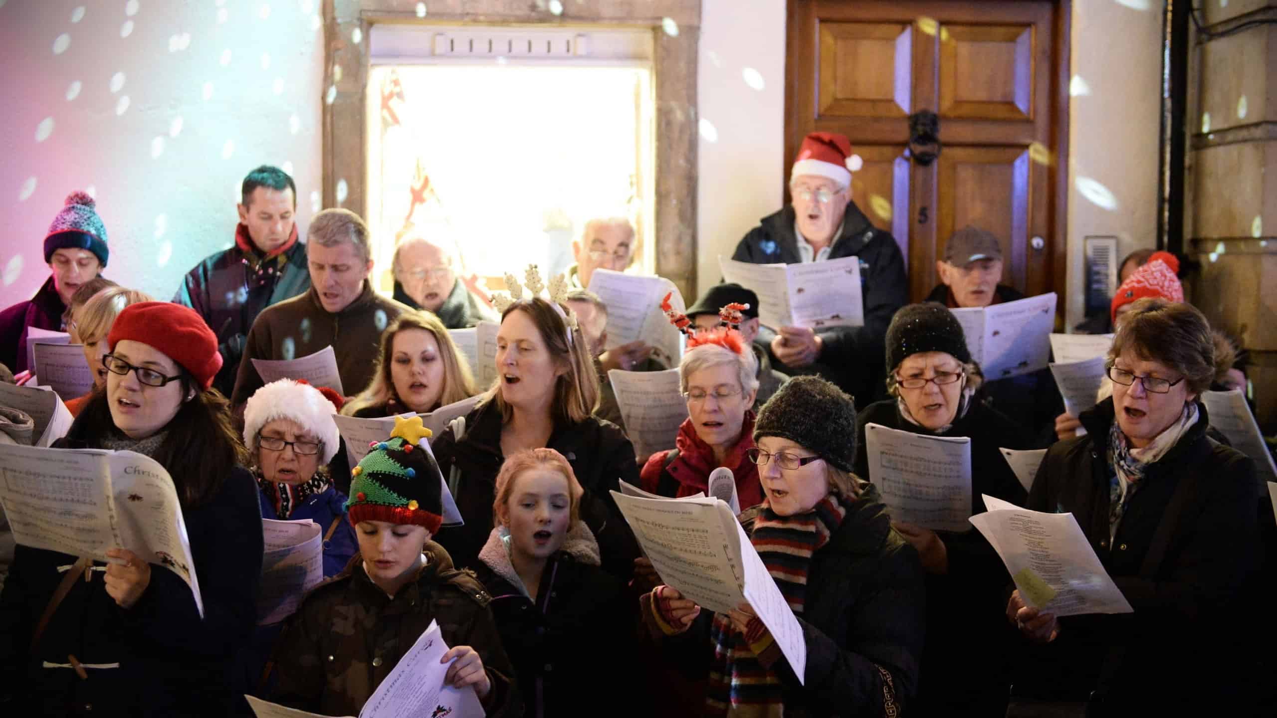 BATH - NOV 30: People sing carols at the Christmas Market in the streets surrounding Bath Abbey on Nov 30, 2014 in Bath, UK. The market is held annually in the historic Unesco World Heritage City.