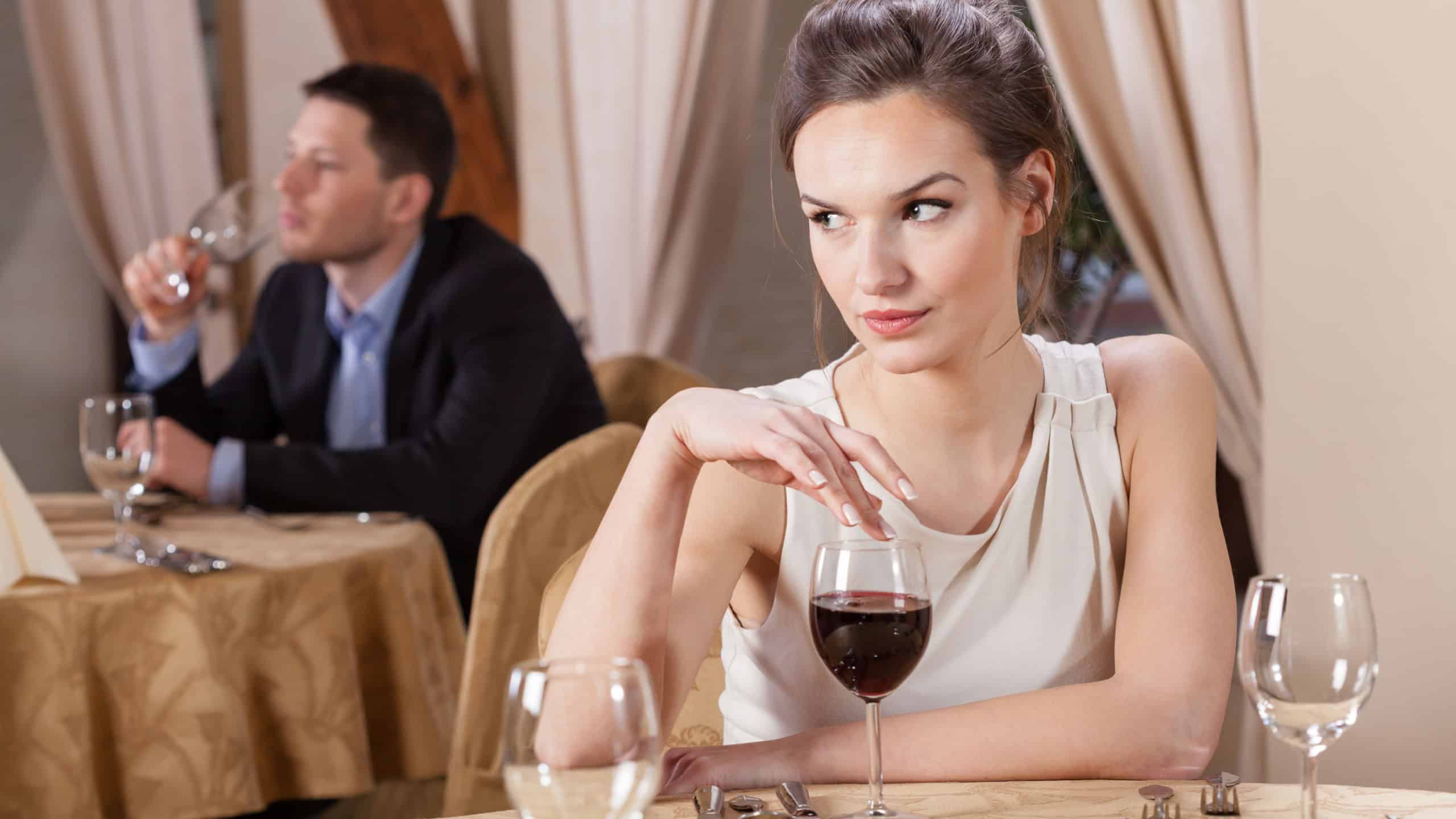 Single woman drinking wine in a restaurant