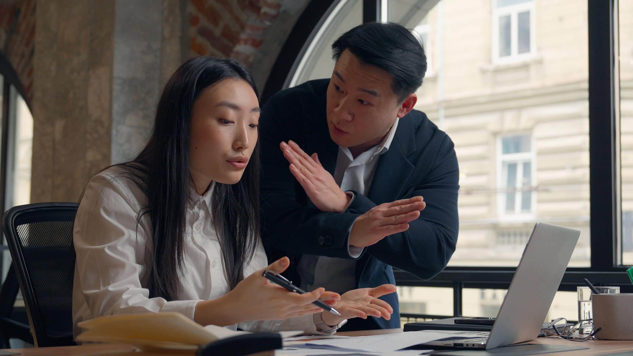 Asian woman Korean girl office manager intern businesswoman working paperwork laptop check data documents research Chinese man Japanese business male boss leader angry shouting dissatisfied bad work