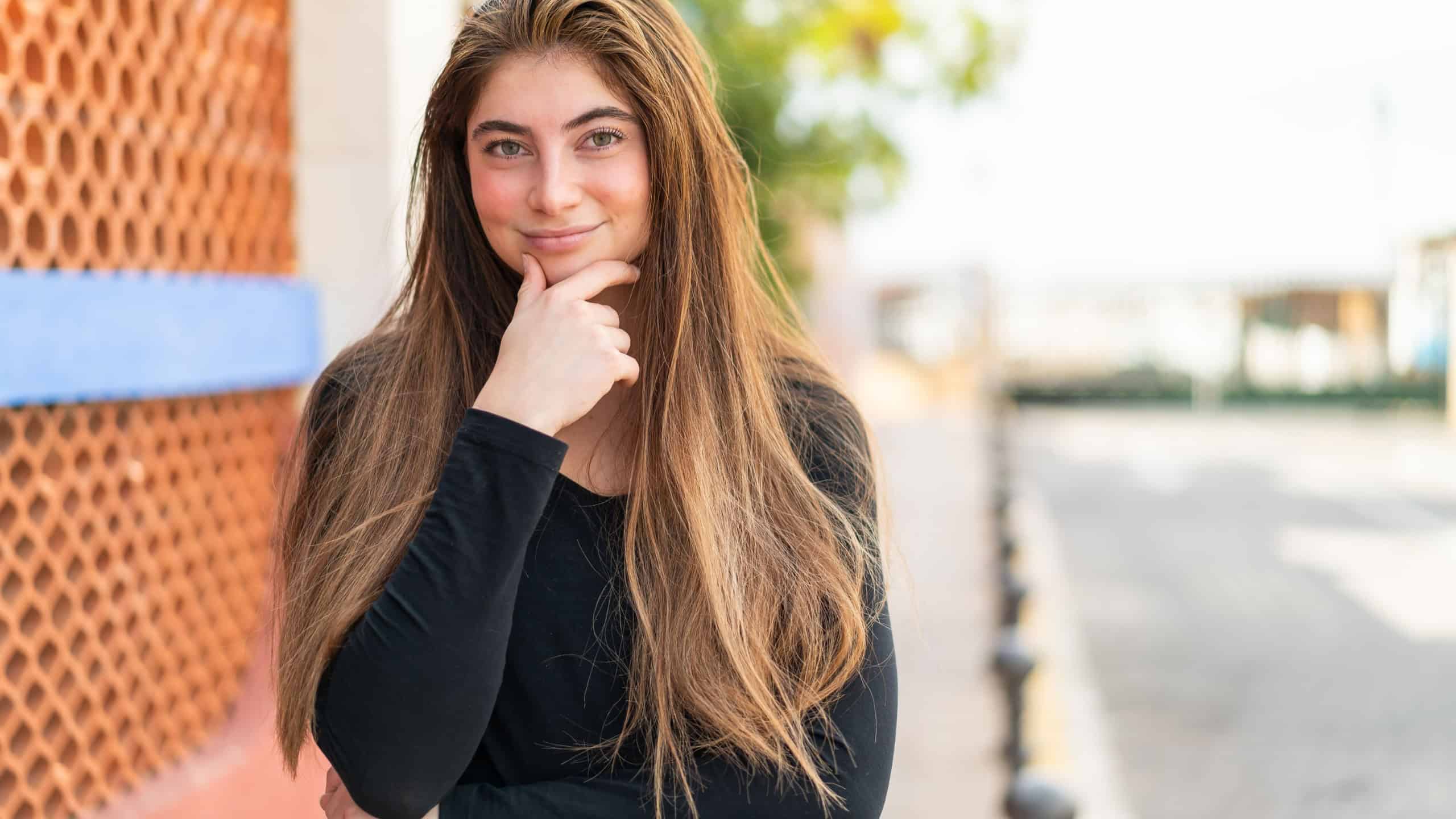 Young pretty caucasian woman thinking