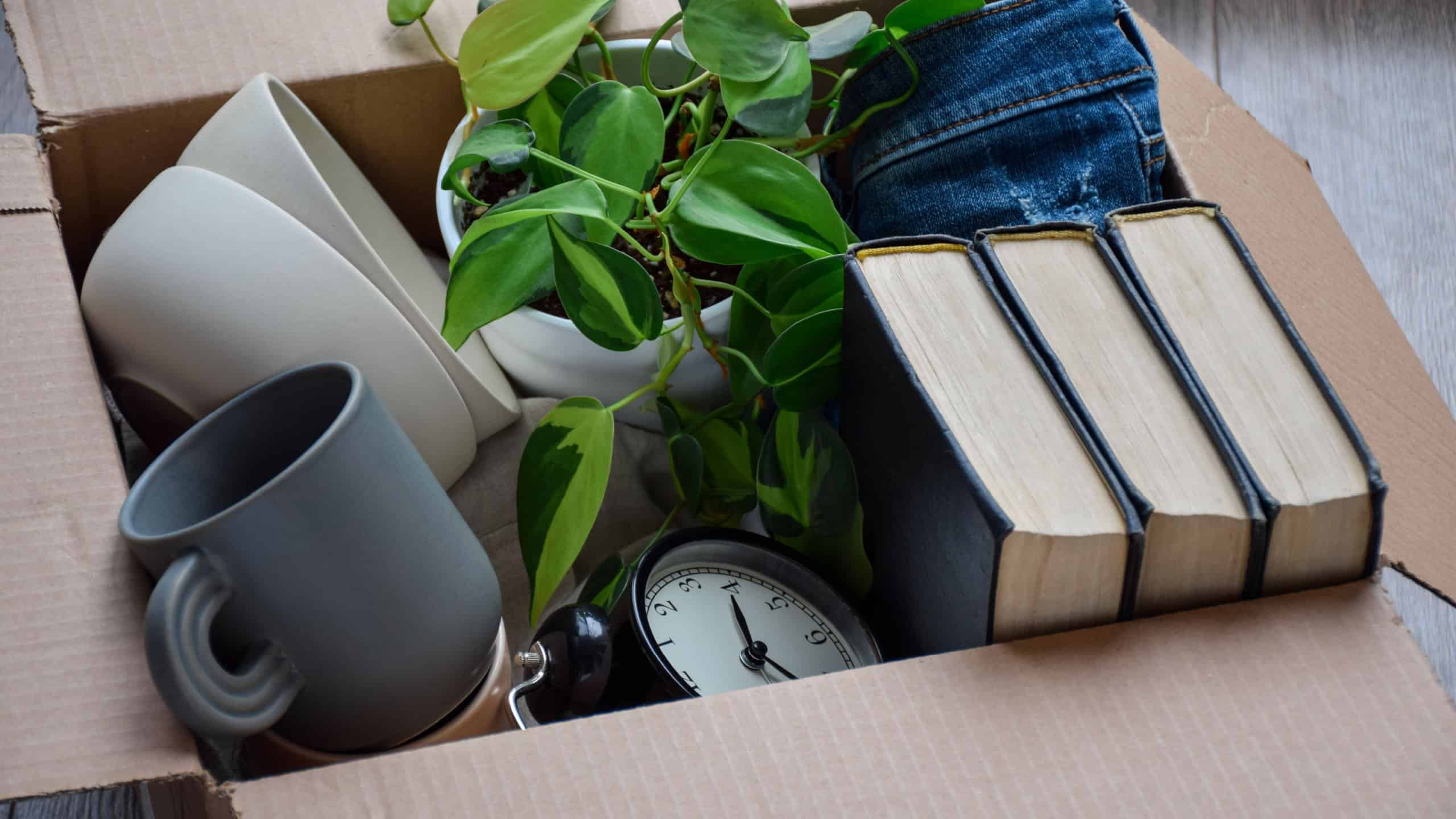 Cardboard box packed with personal belongings for moving