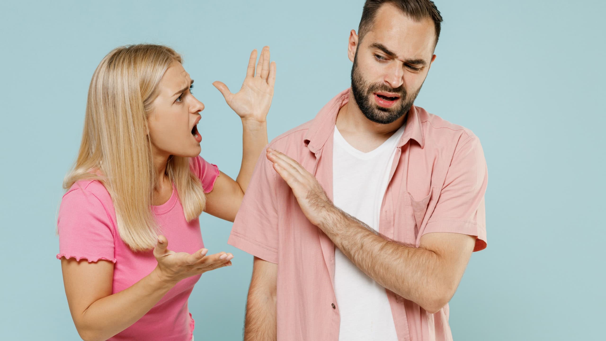 Young arguing sad couple two friends family man woman 20s in casual clothes screaming scolding together isolated on pastel plain light blue color background studio portrait People lifestyle concept