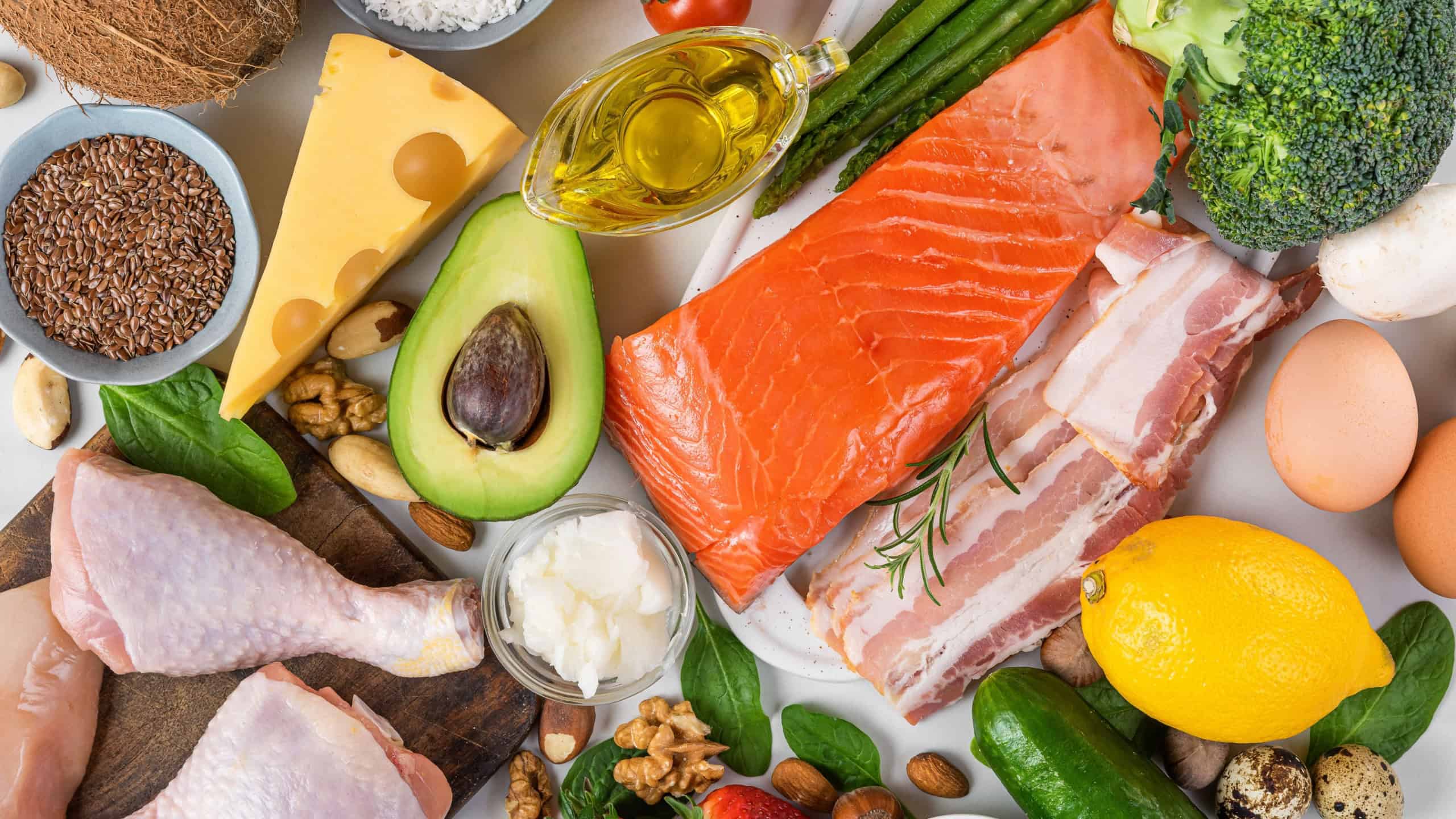 Balanced low carb keto diet food. Food sources of protein, healthy fats, carbs. Top view. Fish, meat, vegetables, fruits, nuts, eggs for ketogenic diet