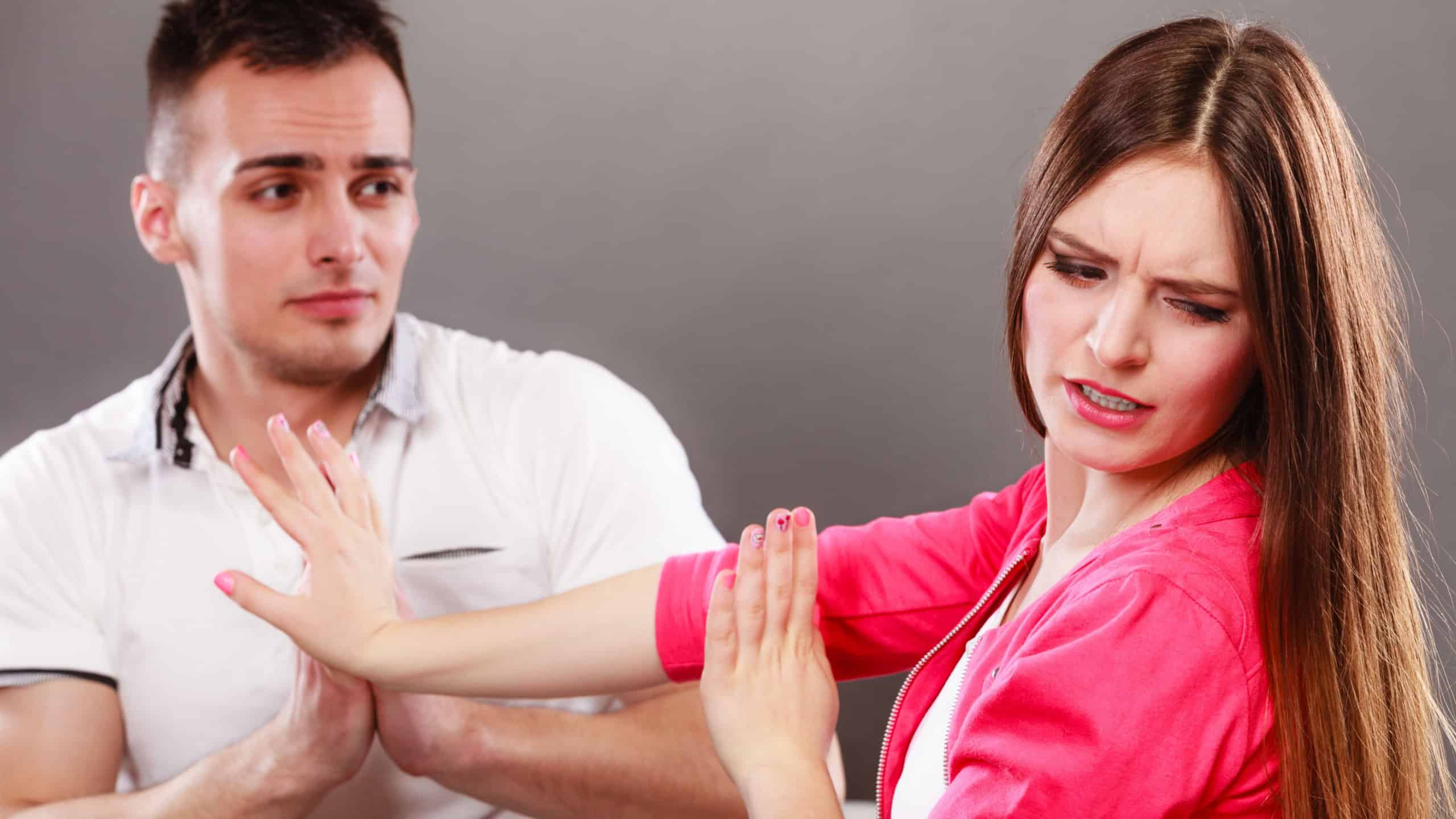 Husband apologizing wife. Upset, angry, mad woman refuses apology pushing him away. Boyfriend trying to convince girlfriend. Man asking for forgivness. Conflicted couple. Relationship problem.