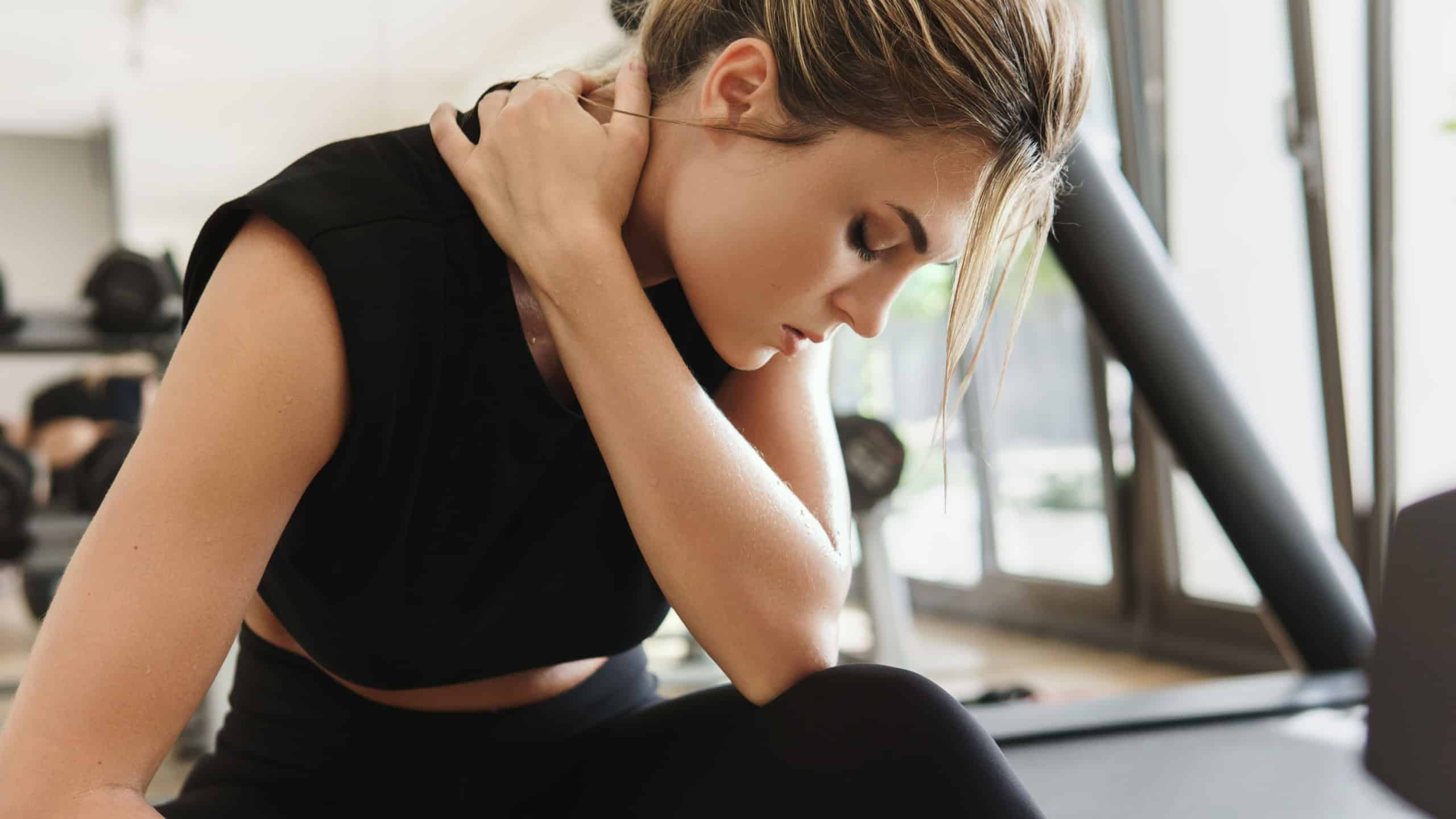 Exhausted athletic woman after her fitness workout in the gym