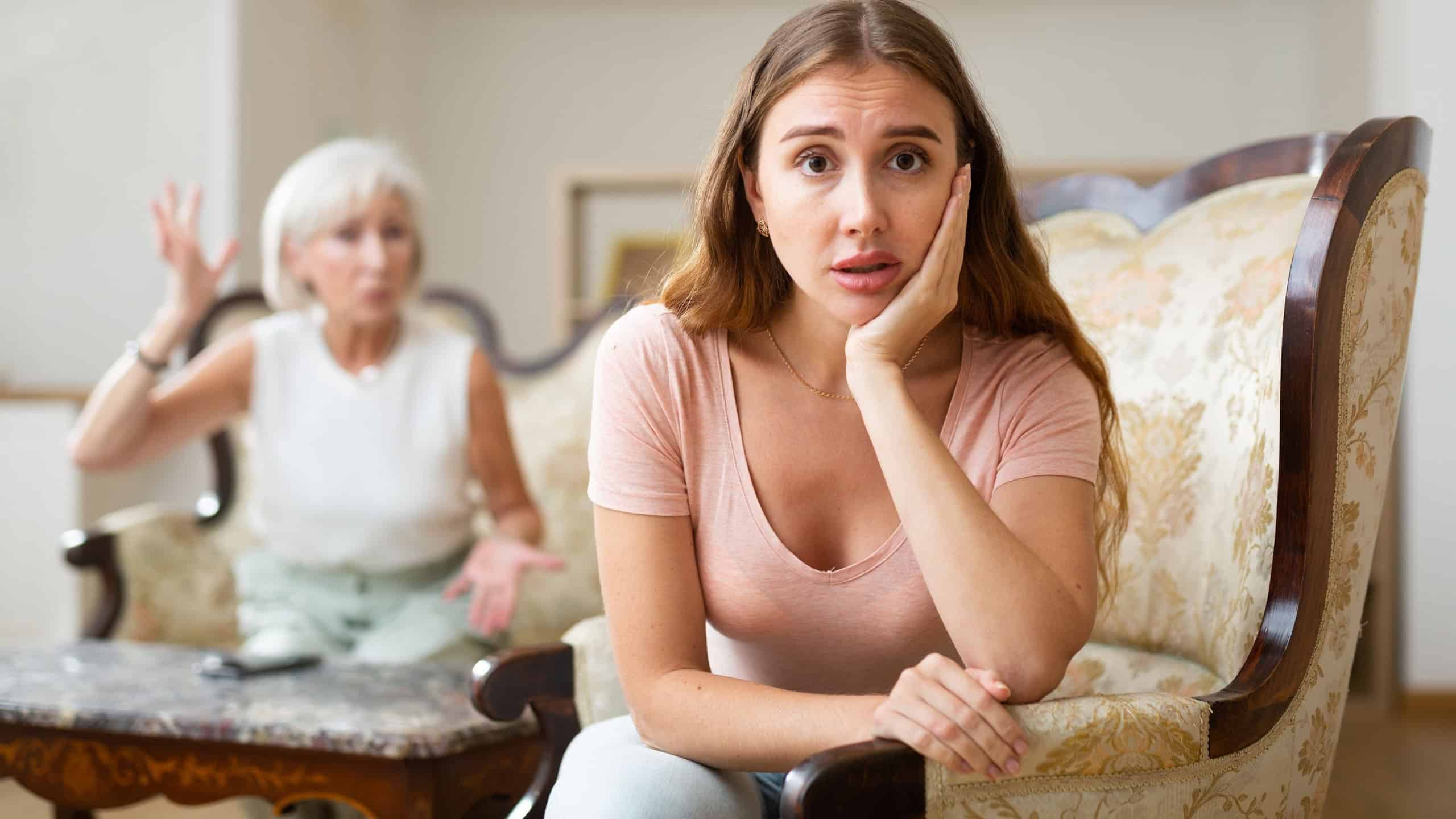 Domestic quarrel between elderly mother and adult daughter in the living room