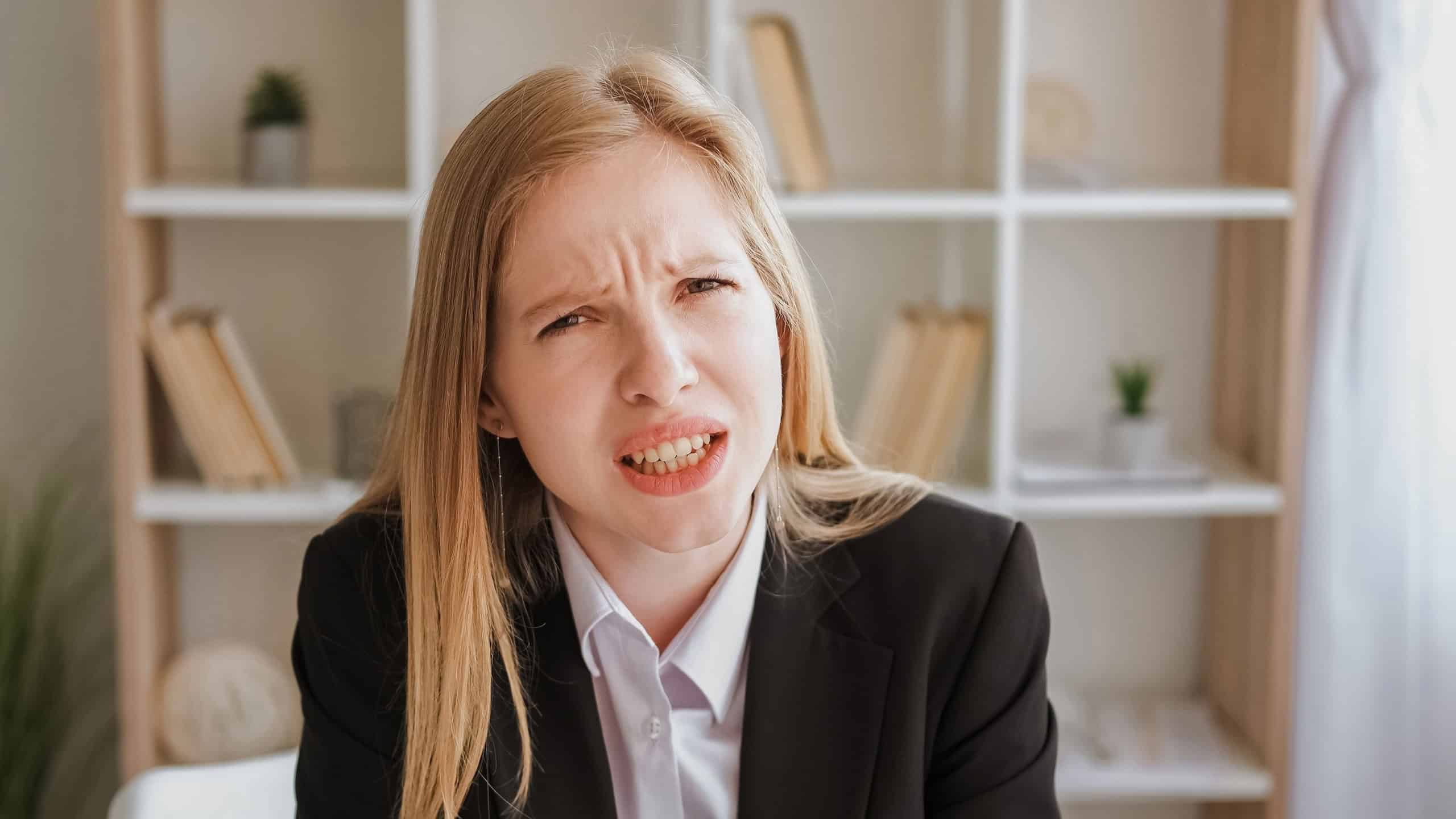 Annoying communication. Indignant expression. Confused disbelief. Irritated angry blond young business woman asking question leaning forward at office.