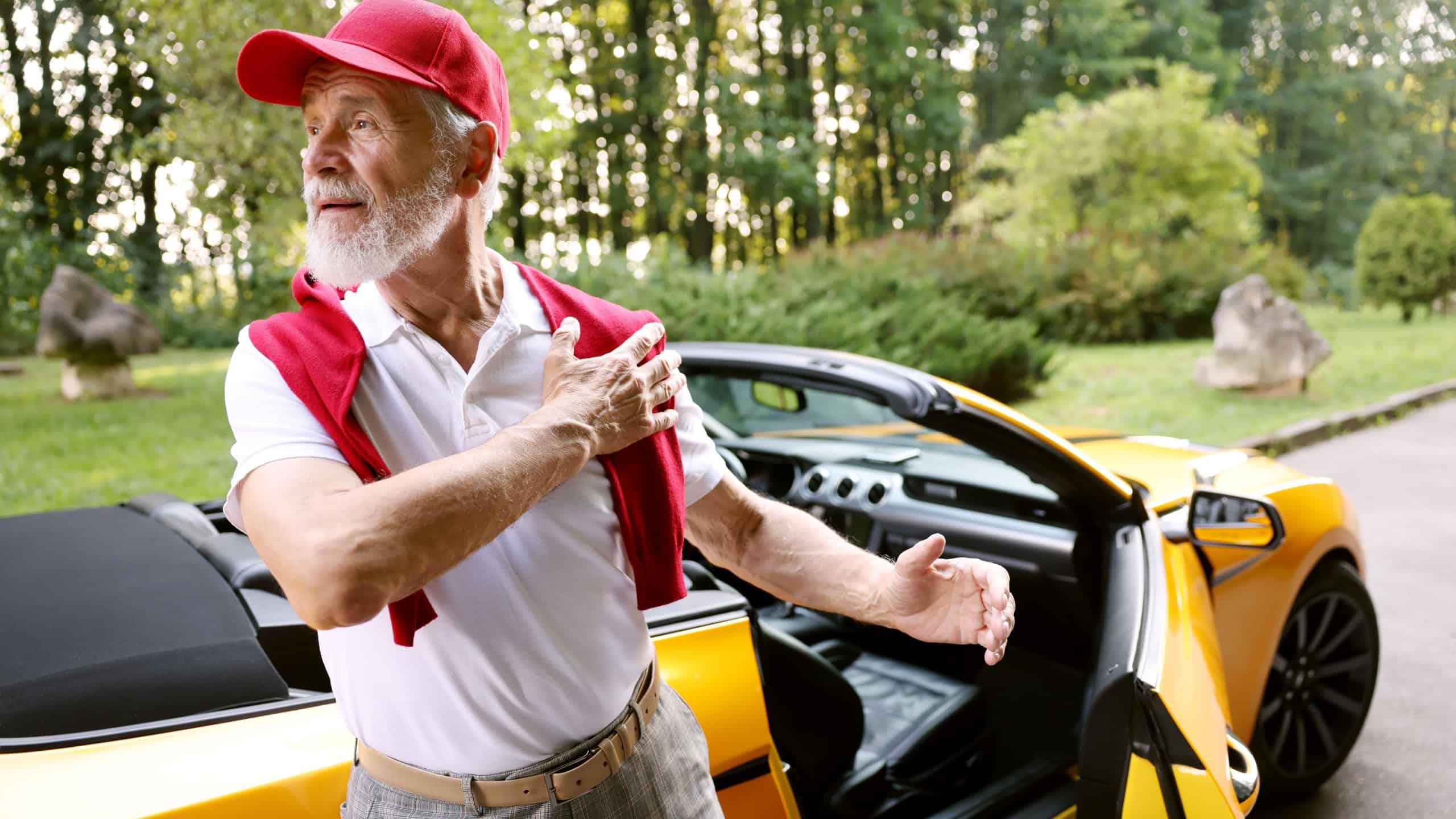 Stylish senior man near modern cabriolet outdoors