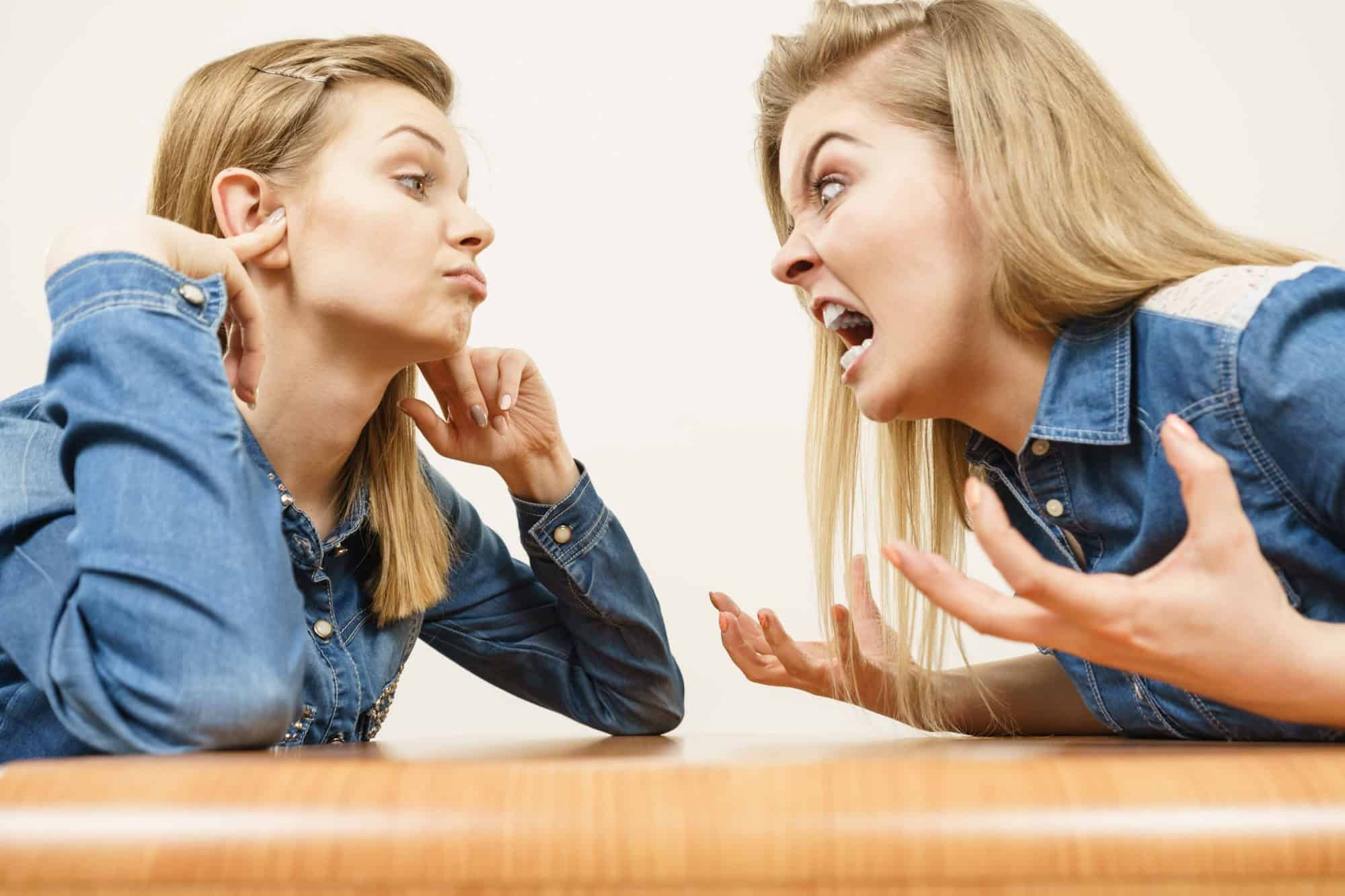 Two women having argue mocking up being mad at each other. Female telling off, ignorance concept.