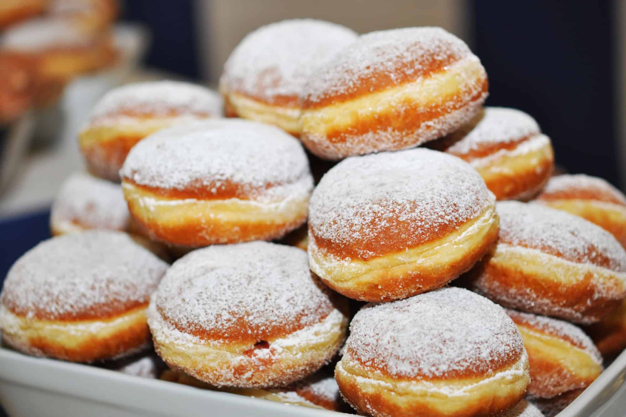 Donuts with powdered sugar in a bowl