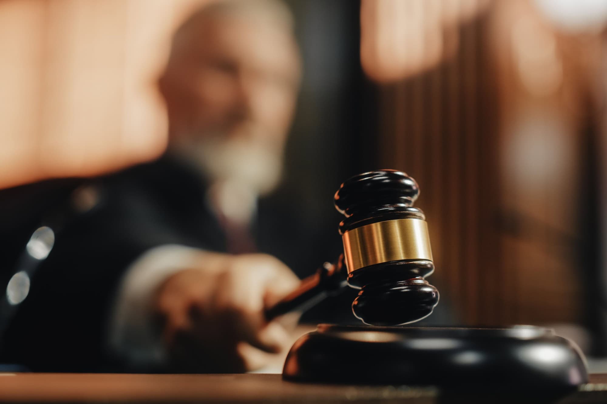Court of Law and Justice Trial Session: Imparcial Honorable Judge Pronouncing Sentence, striking Gavel. Focus on Mallet, Hammer. Cinematic Shot of Dramatic Not Guilty Verdict. Close-up Shot.