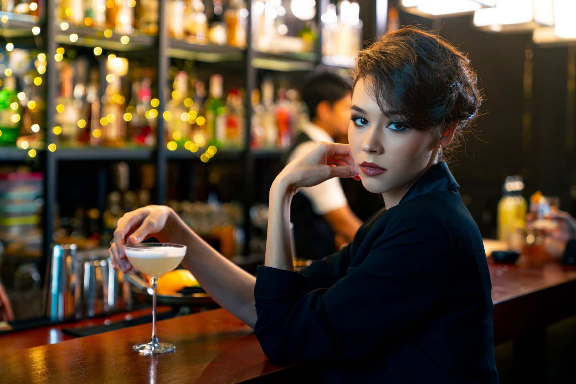 Confidence Caucasian woman hangout drinking alcoholic cocktail on holiday vacation at luxury restaurant bar. Cheerful people enjoy and fun hanging out meeting nightlife celebration party at nightclub.
