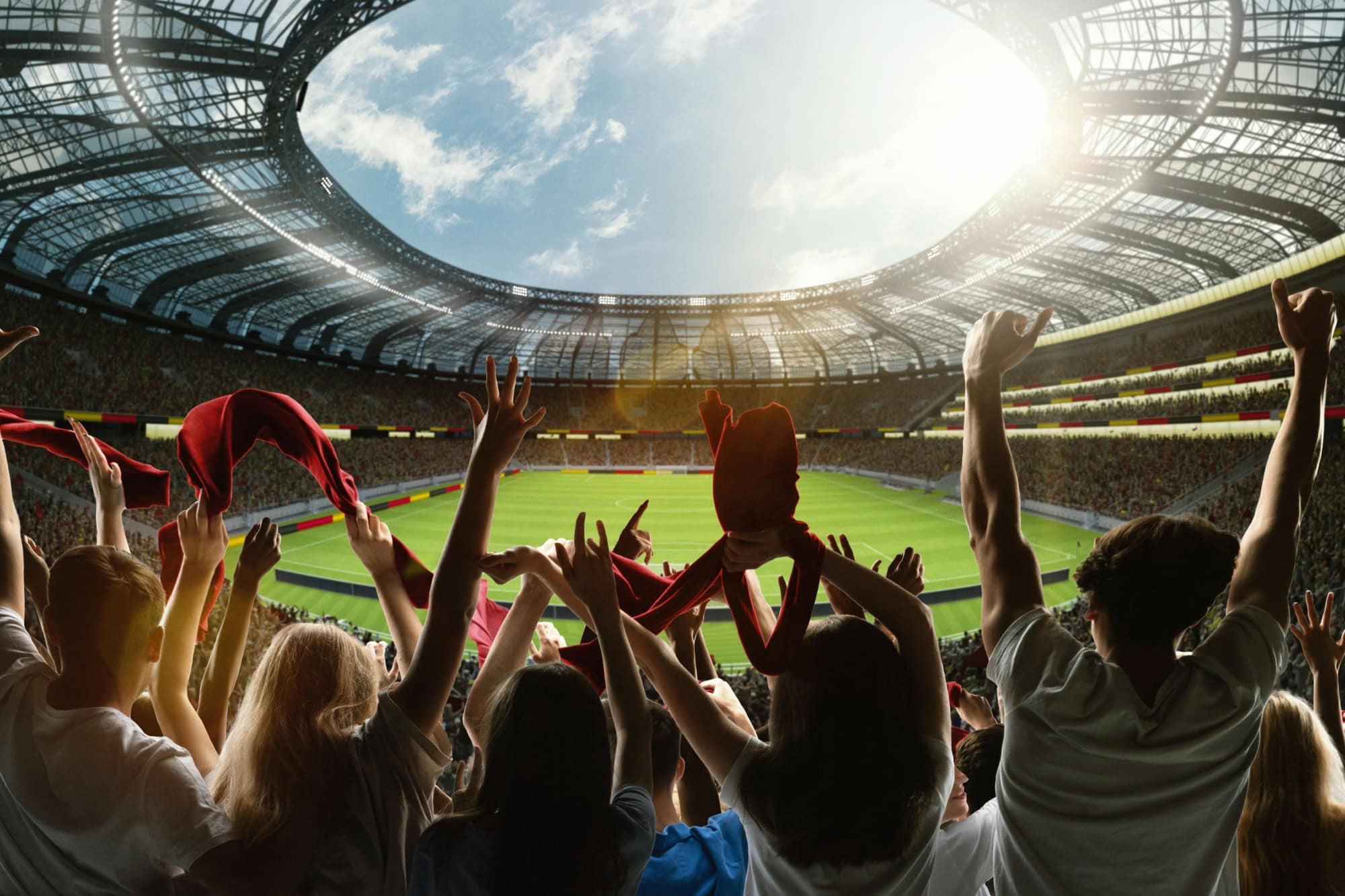 Emotional soccer fans. Enthusiastic supporters cheering with scarves and arms raised at massive stadium. Passion of the game. Concept of sport, emotions, competition, tournament.