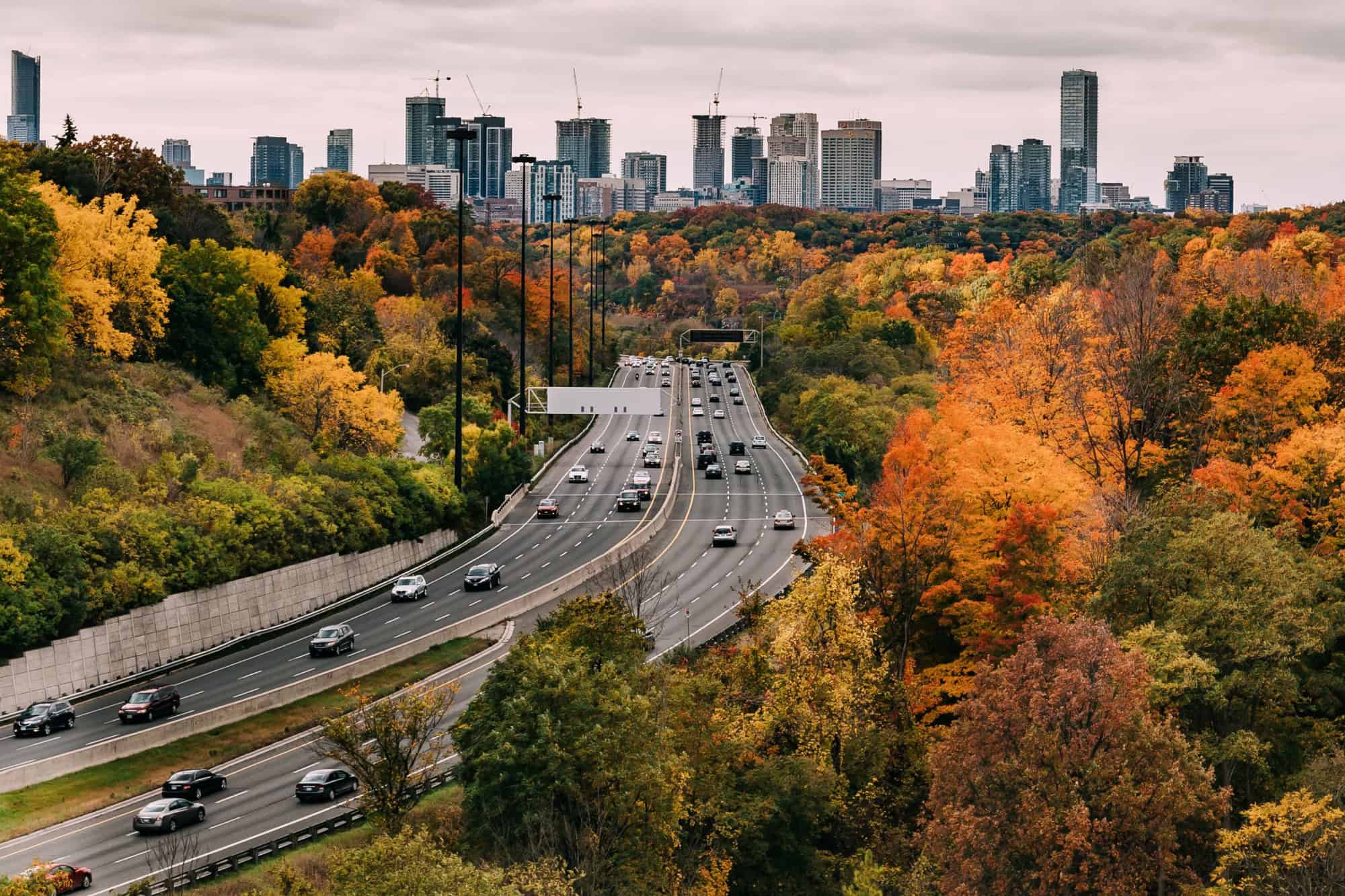  Cars on the Don Valley Highway in Toronto during the Fall. The city can be seen in the distance.