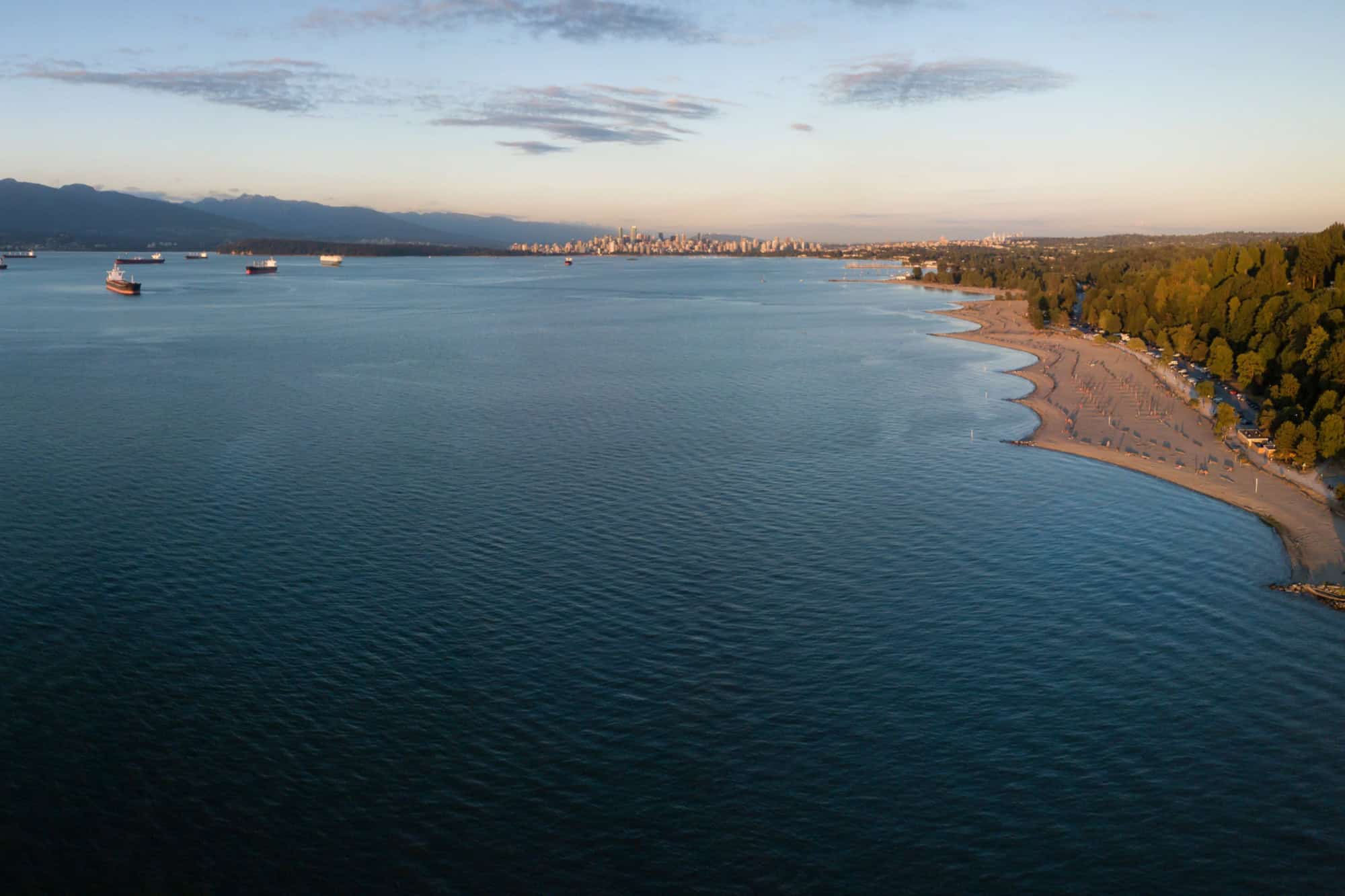 Aerial view of Spanish Banks Beach with Downtown Vancouver, British Columbia, Canada, in the background. Picture taken during a sunny summer sunset.