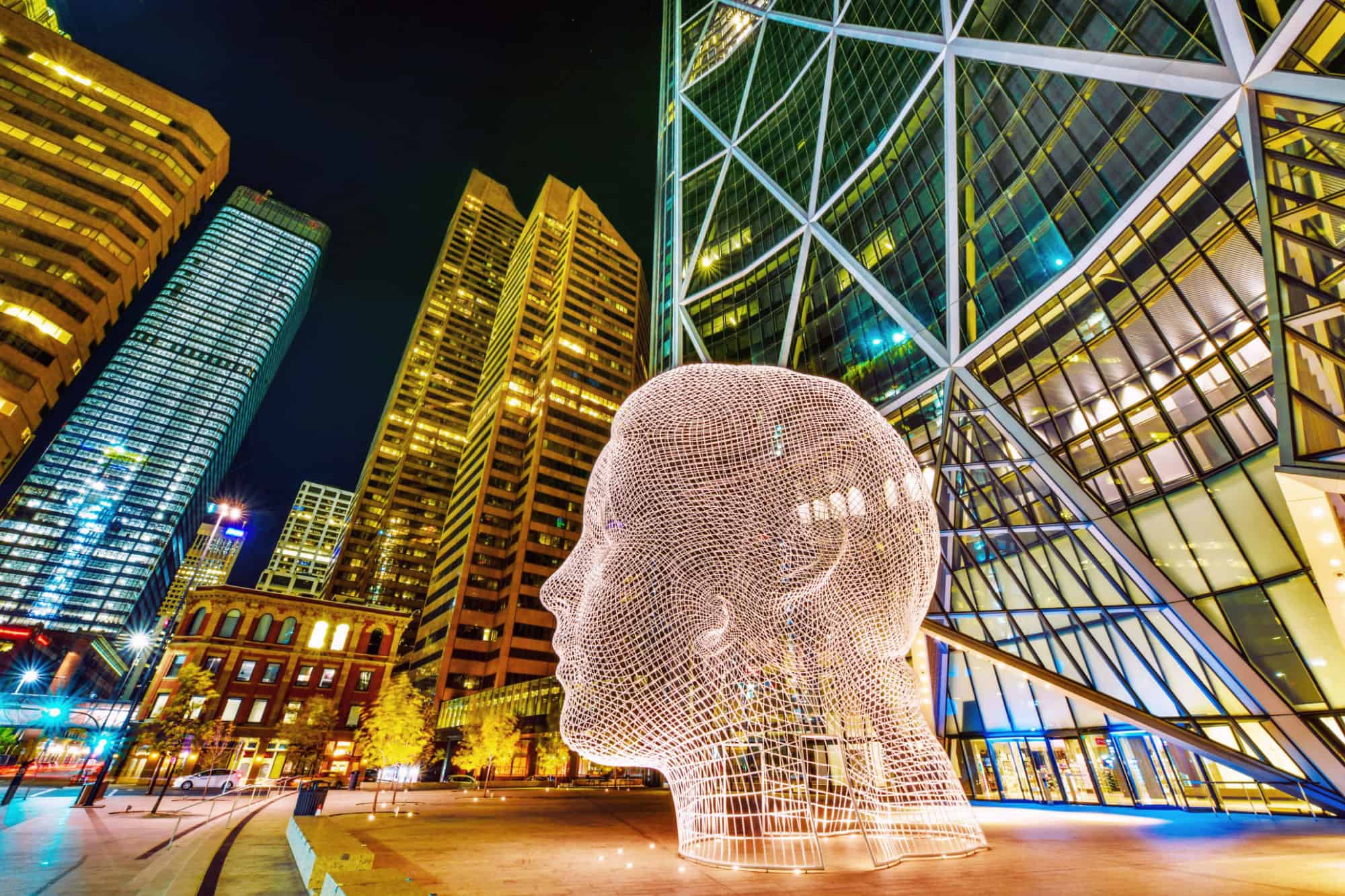 Night view of the popular "Wonderland" sculpture by famous artist Jaume Plensa sits in-front of The Bow tower in Calgary, Alberta,Canada