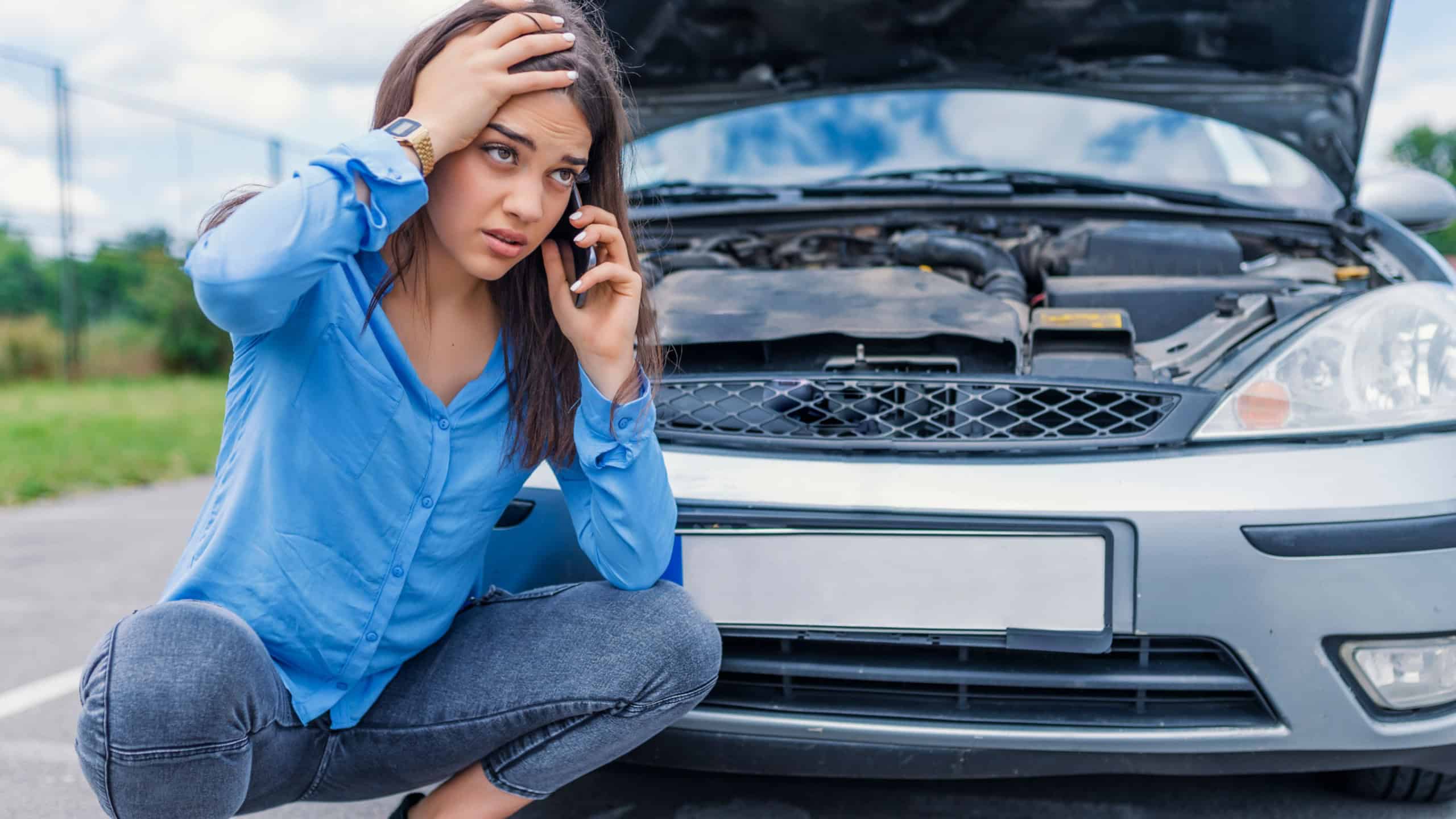 Hello, I have problems with my car! Calling Emergency Service. Young woman with a broken car. Sad girl with a broken car with open hood. Broken car, accident, feeling confusion and people concept
