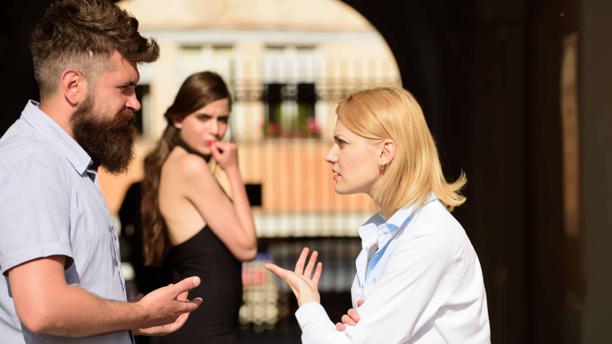 Who is she. Love triangle problem. Family conflict. Jealous woman blaming unfaithful man for having a lover. Conflict in romantic relationship involving three people. Romance triangle and adultery.