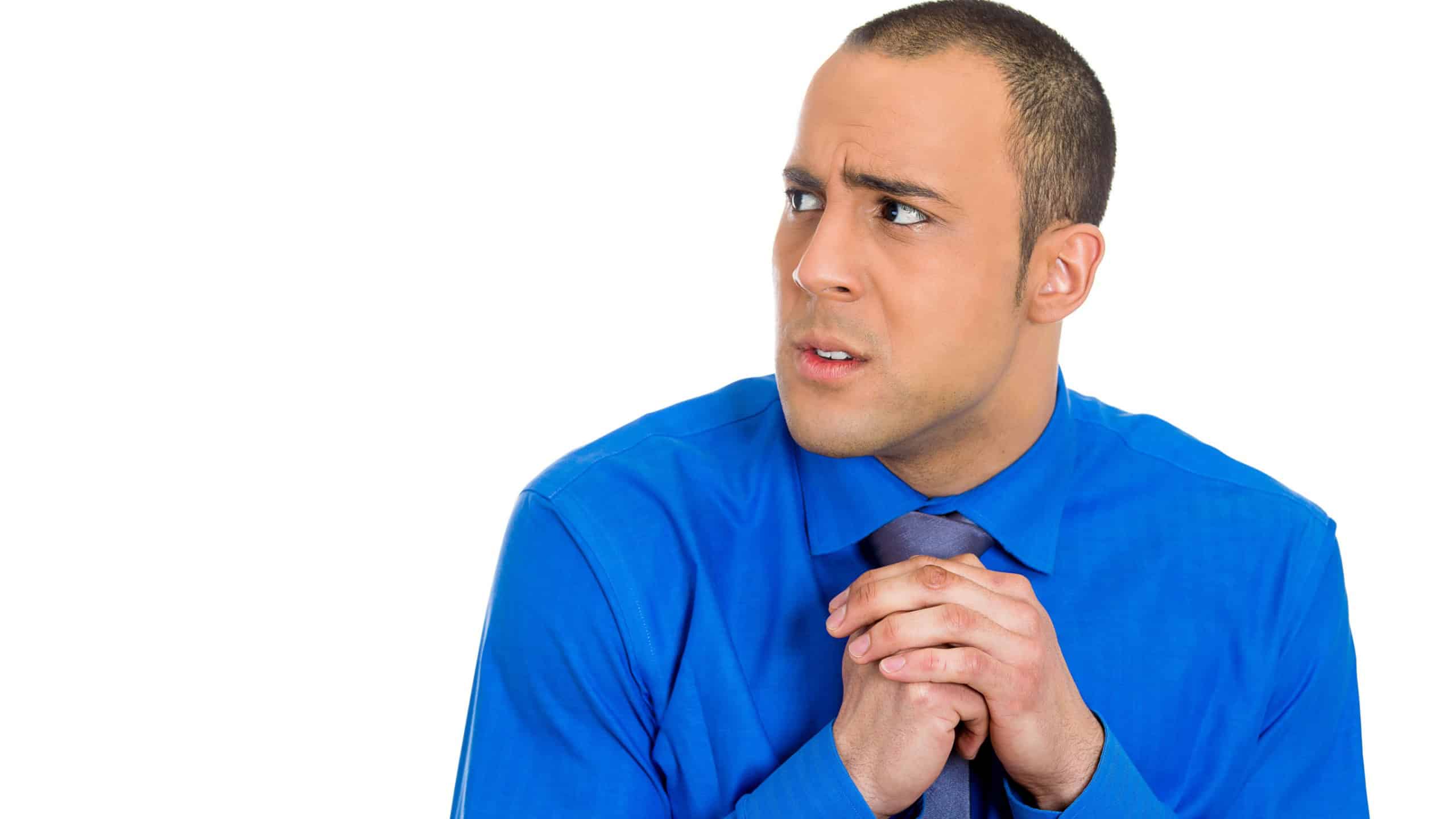 Closeup portrait of a young man with shirt, very timid, shy and anxious, playing with hands nervously looking to side, isolated on a white background. Mental health, emotion facial expression feeling