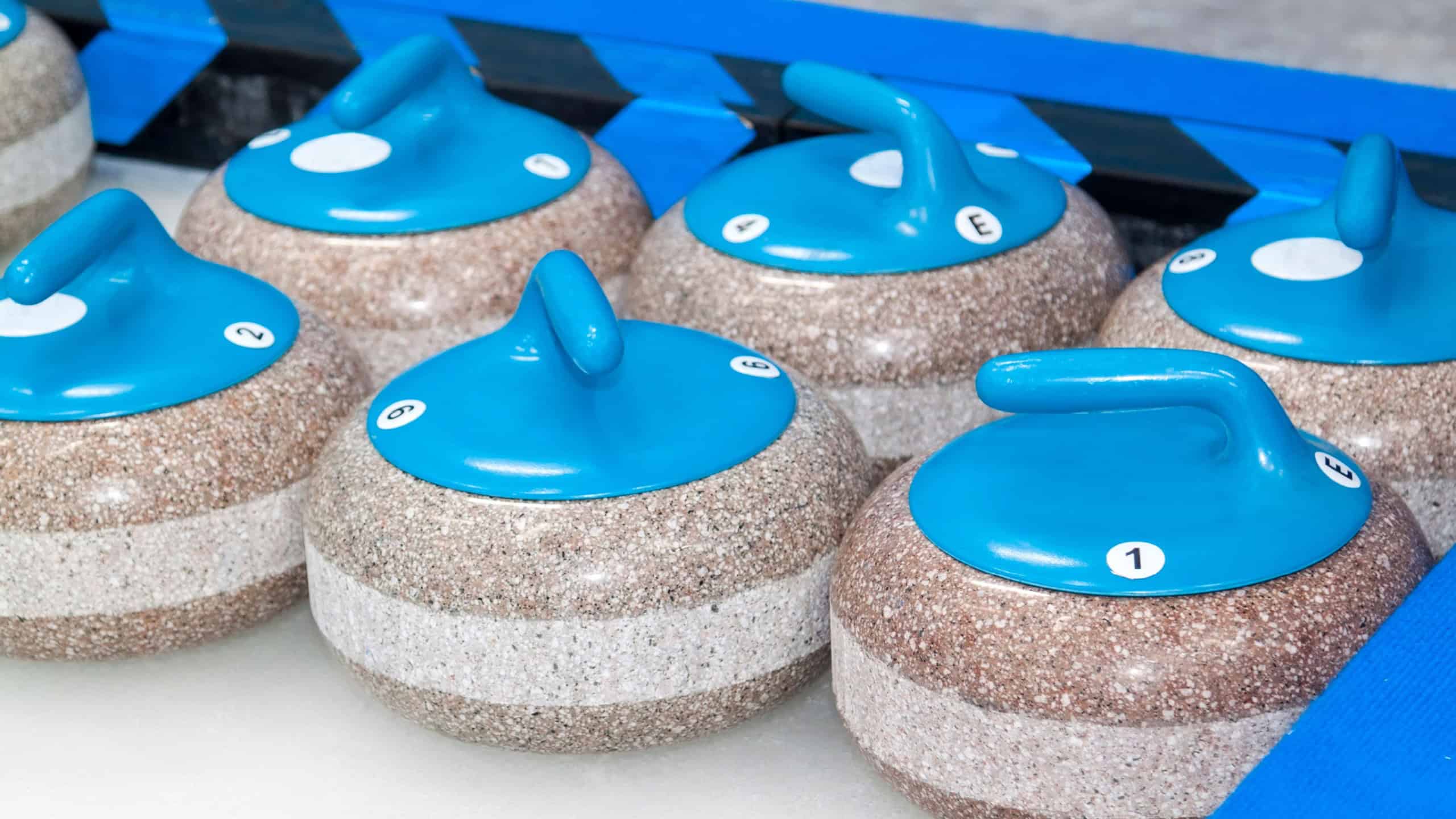 Close up view of group of blue stones for Curling on ice