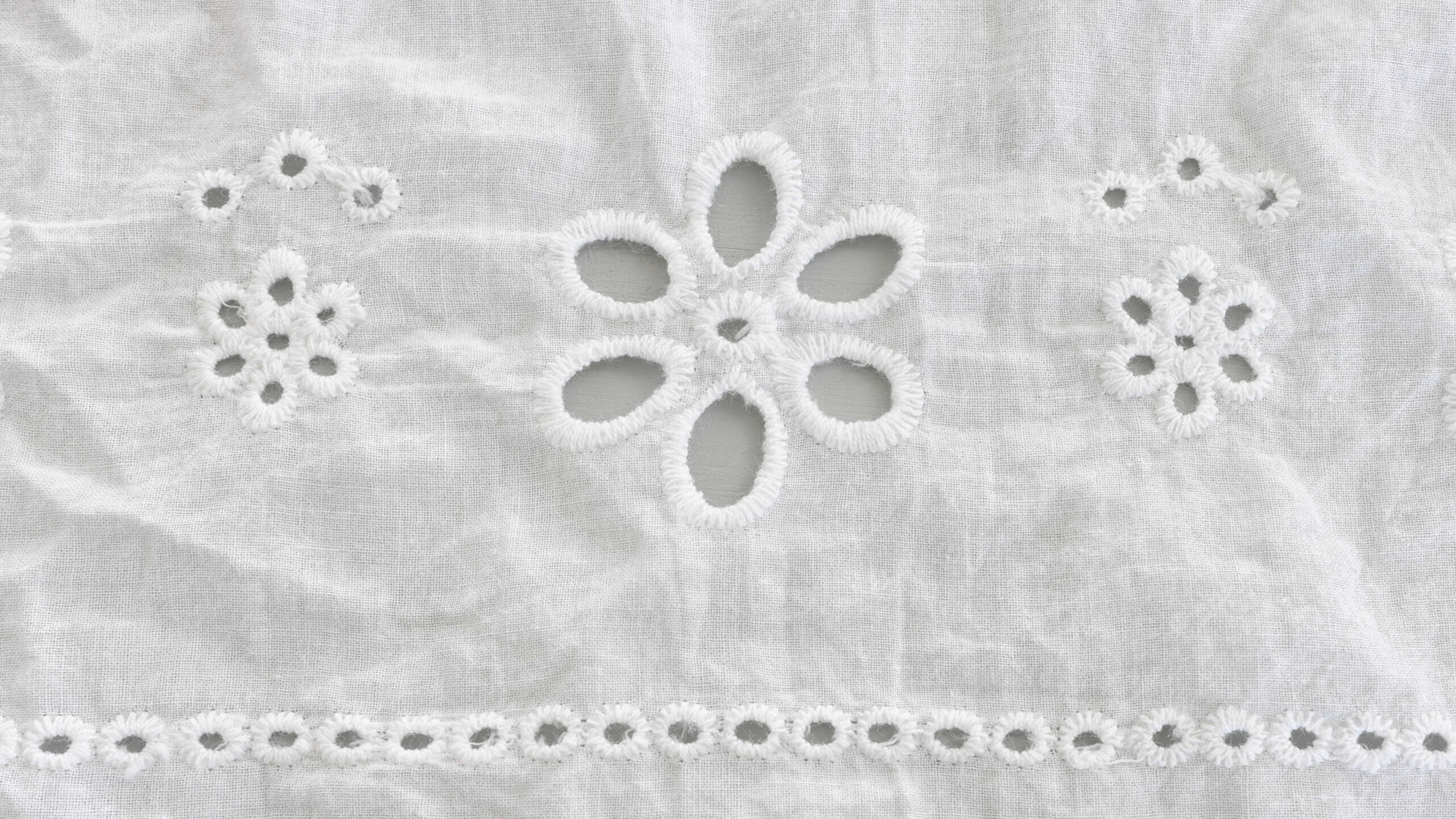 Background of white embroidered delicate lace fabric