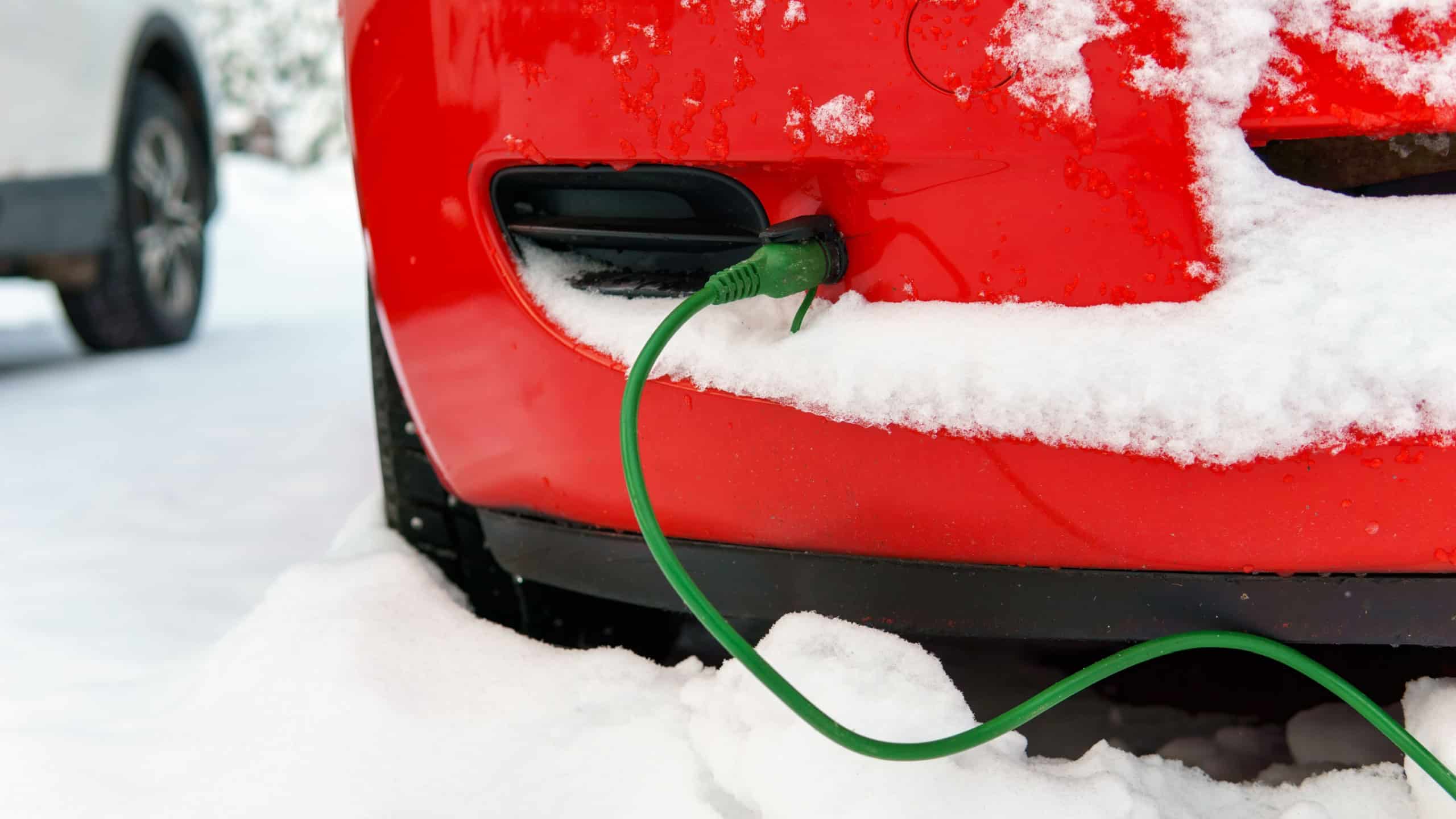 Block heater cable plugged into a car on a cold winter day to warm engine.