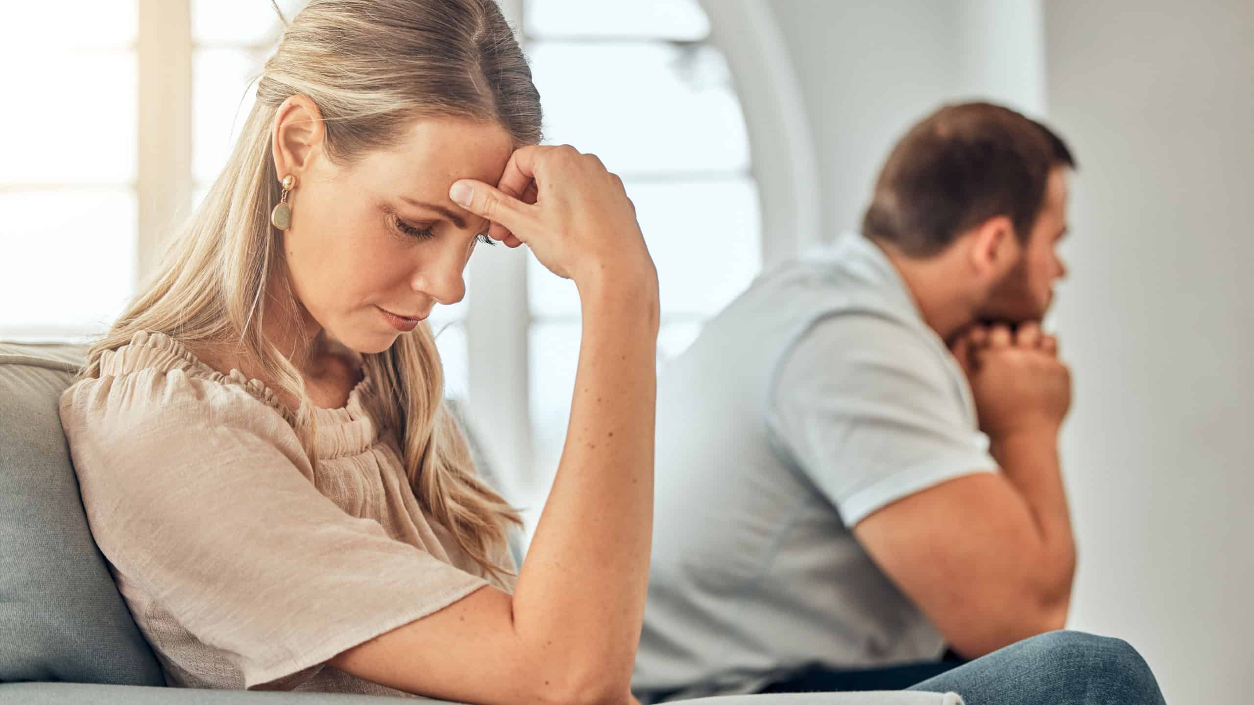 One young woman feeling frustrated and annoyed after an argument with her husband. A wife feeling distant after fighting due to marriage problems. A negative situation that could end up in divorce