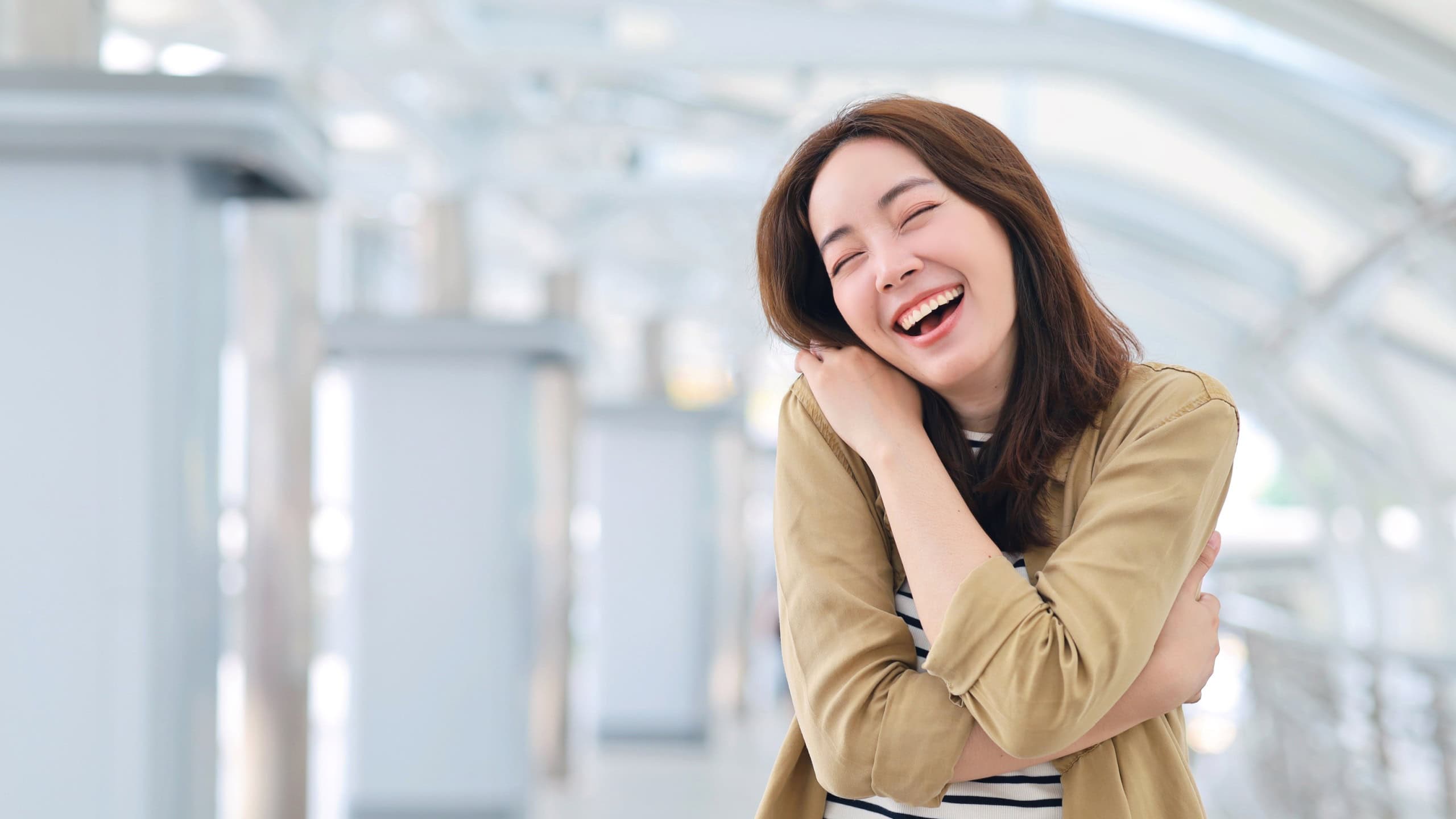 Asian woman in casual style standing hugging herself, Positive self love and self care concept.