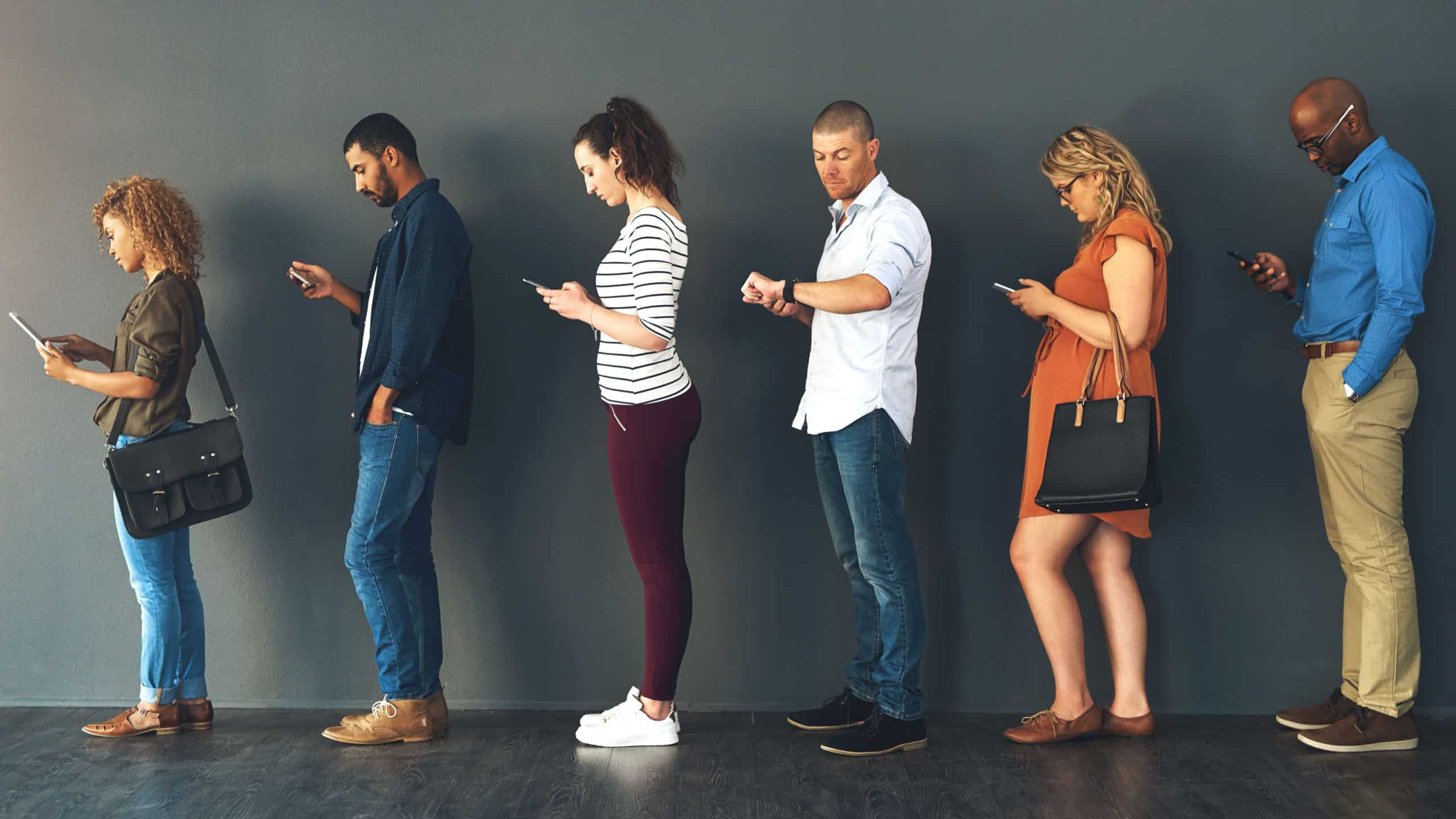 Businesspeople, interview and waiting in queue with technology or job recruitment, onboarding or internet. Men, women and meeting diversity in line or cellphone in office, human resources or hiring