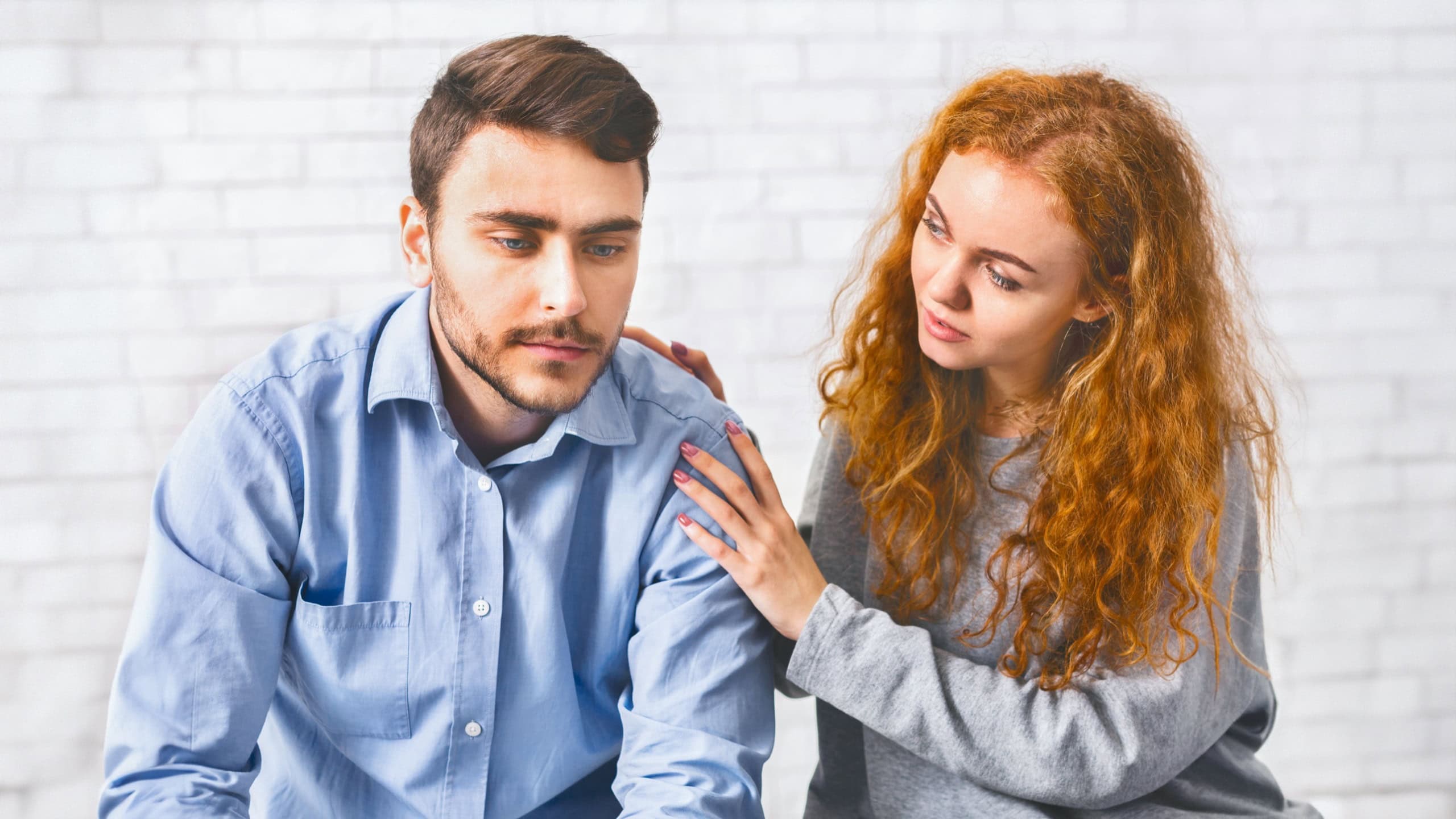 Woman supporting a man