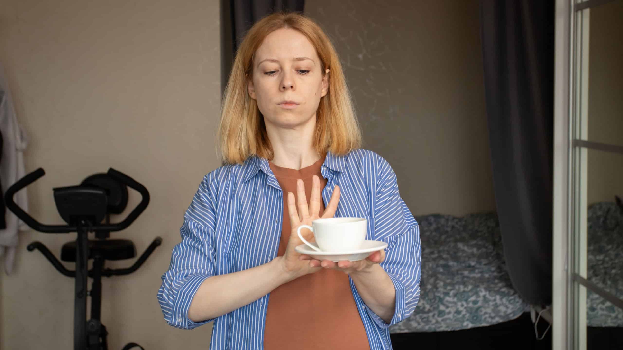 Pregnant woman refuses coffee, embracing a caffeine-free pregnancy, maternal care, healthy habits