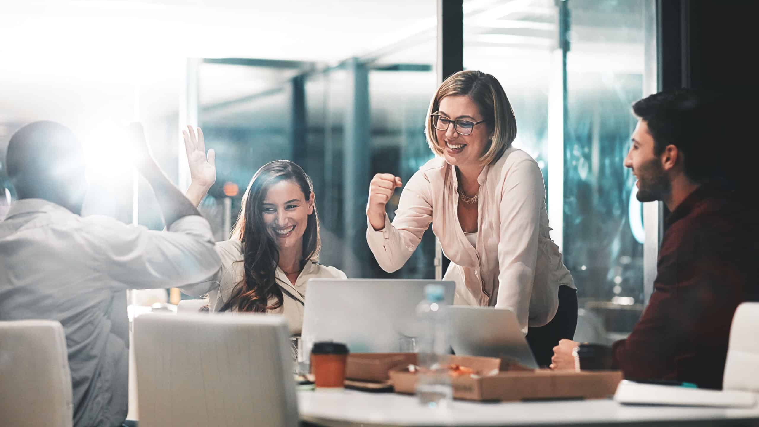 Business people, happy and celebration for success in office with company investment and stock market bonus. Teamwork, employees and support or trading achievement with night and excited in boardroom