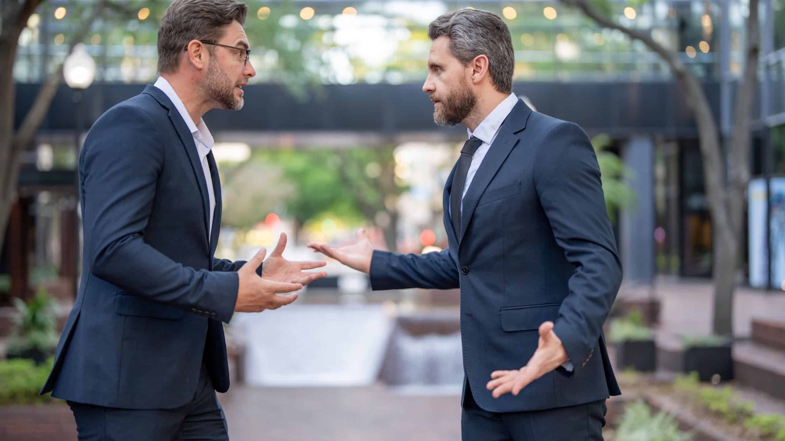 Businessmen fighting outdoor. Angry office workers dispute in city. Disagreed men partners. Business competition. Businessmen have business conflict. Business men aggressive outdoor. Negotiations.
