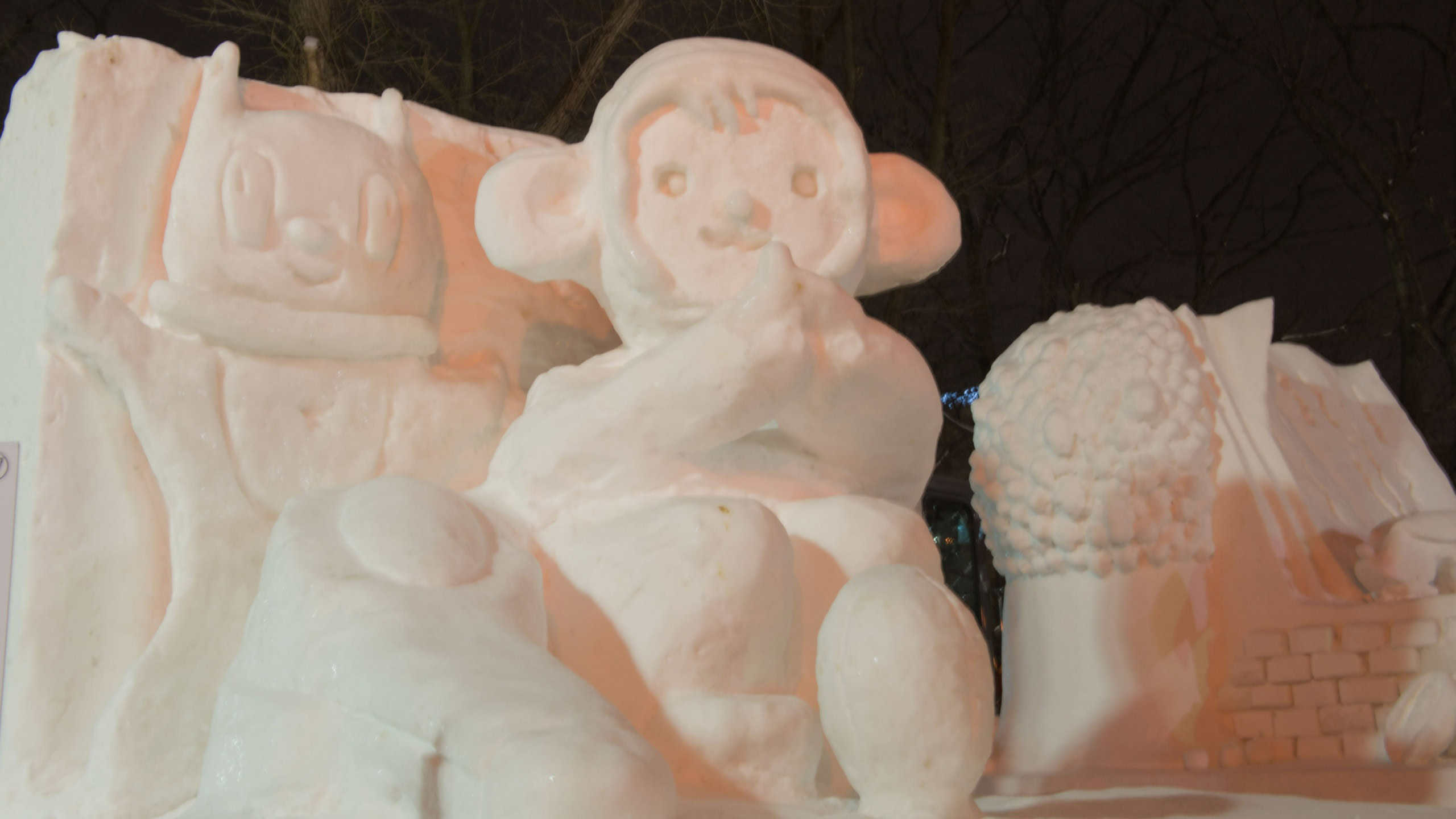 A medium-sized snow sculpture of cartoon characters, including a monkey