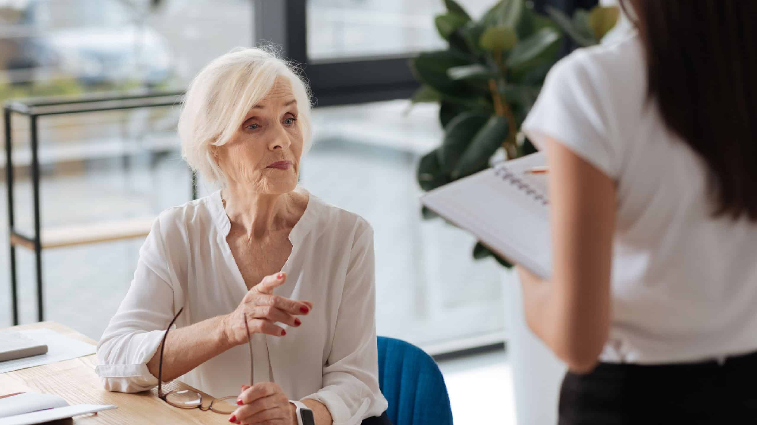 Nice experienced businesswoman giving instruction