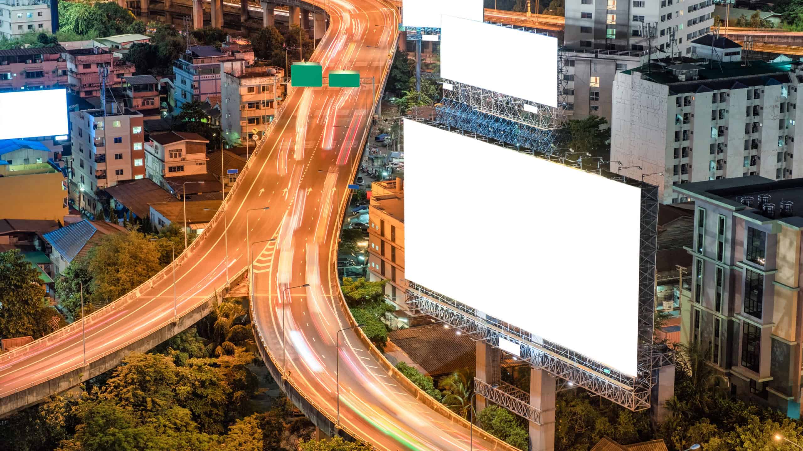 Blank large billboards with traffic on elevated road in a city