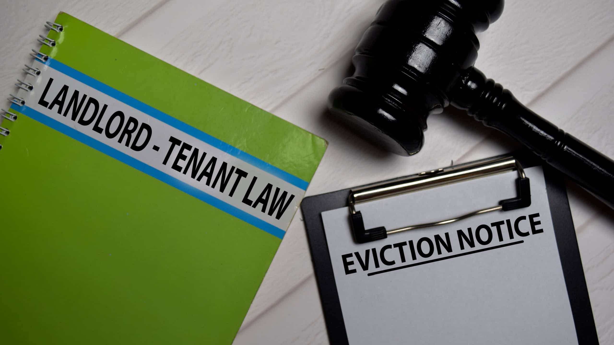 Eviction Notice text on Document form and book Landlord-Tenant Law isolated on office desk.