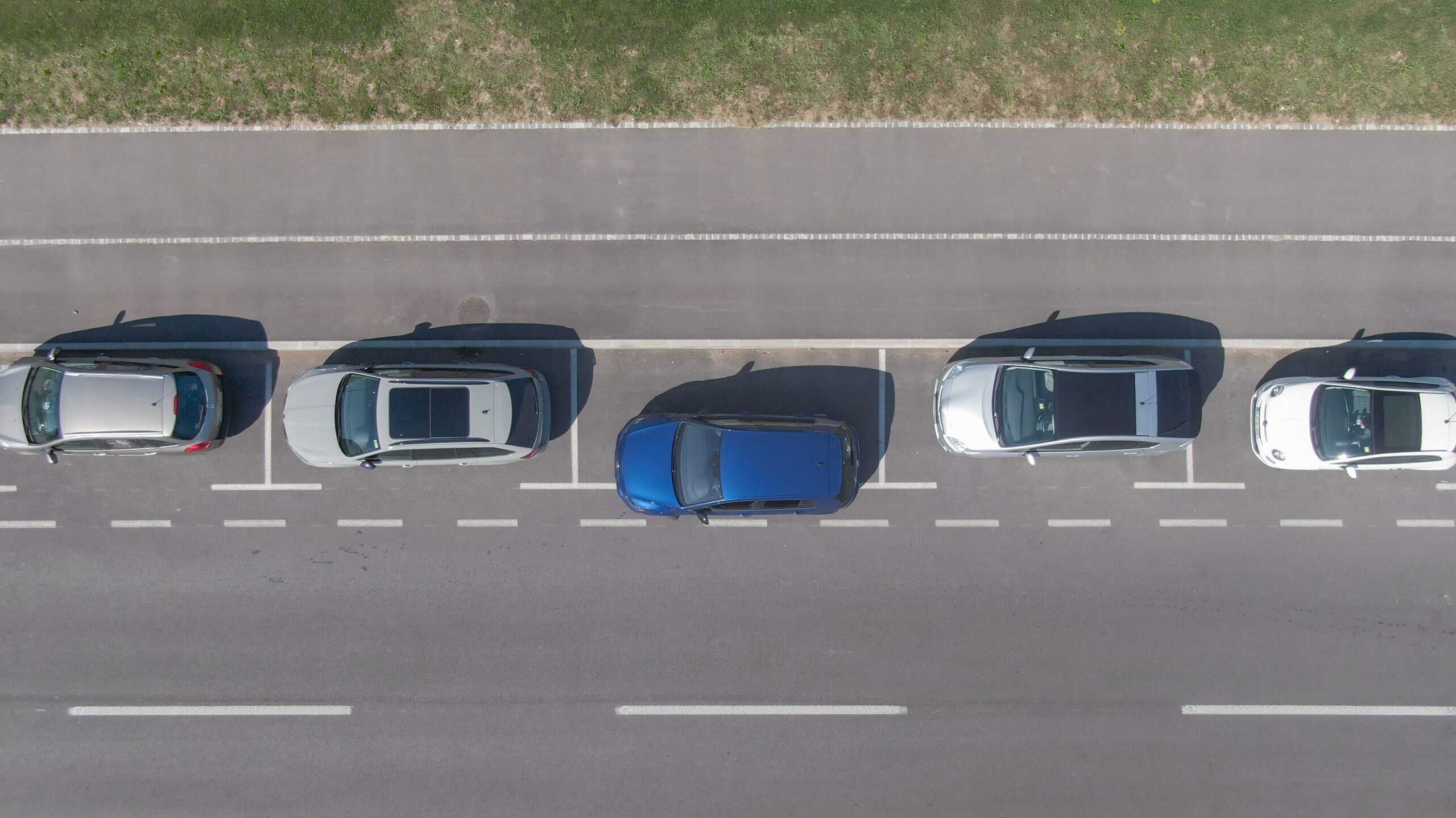 Inexperienced driver poorly parallel parks their new car