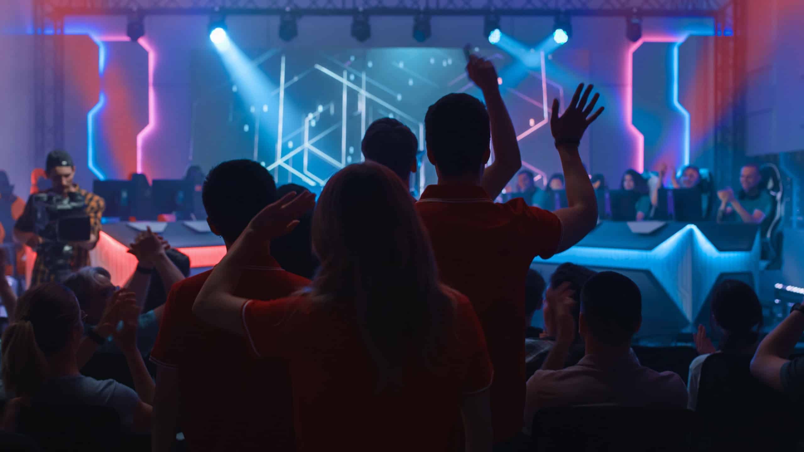 Esport Team of Professional Gamers Enter Video Game Championship Arena. Cyber Games Tournament Event with Crowd of Fans Cheering for Favourite Players. Online Streaming Entertainment.