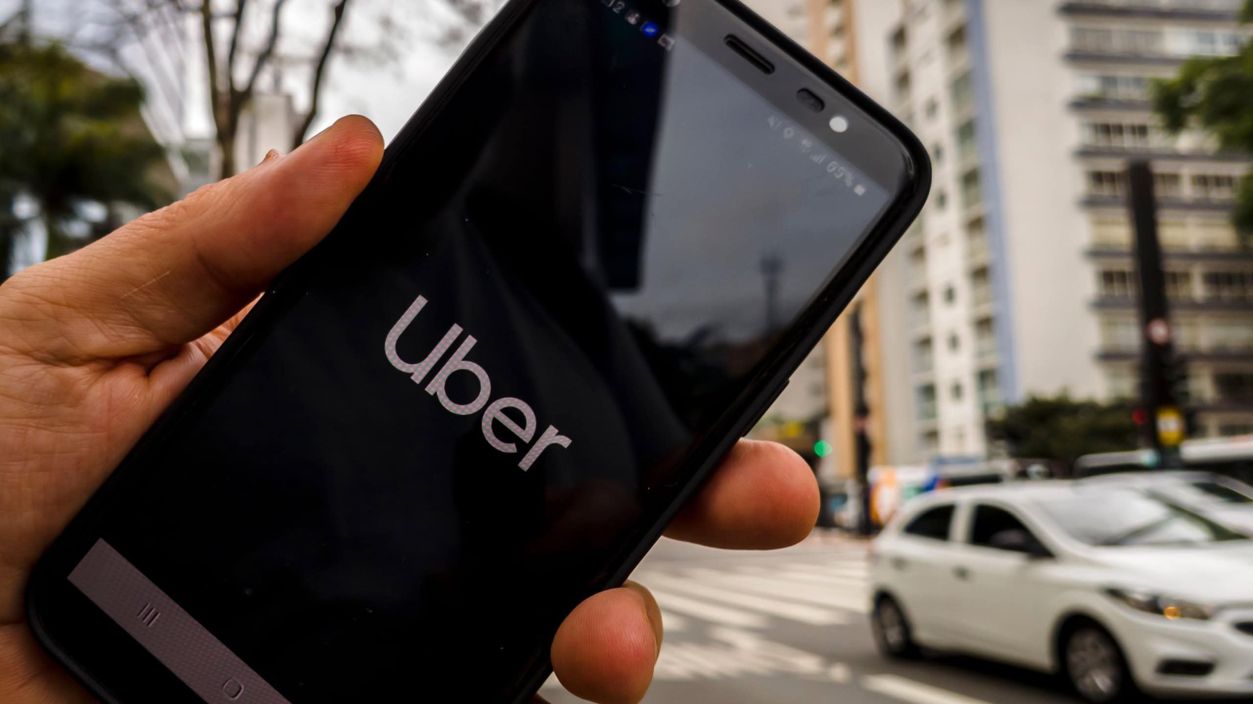 Uber app displayed on smartphone held in hand