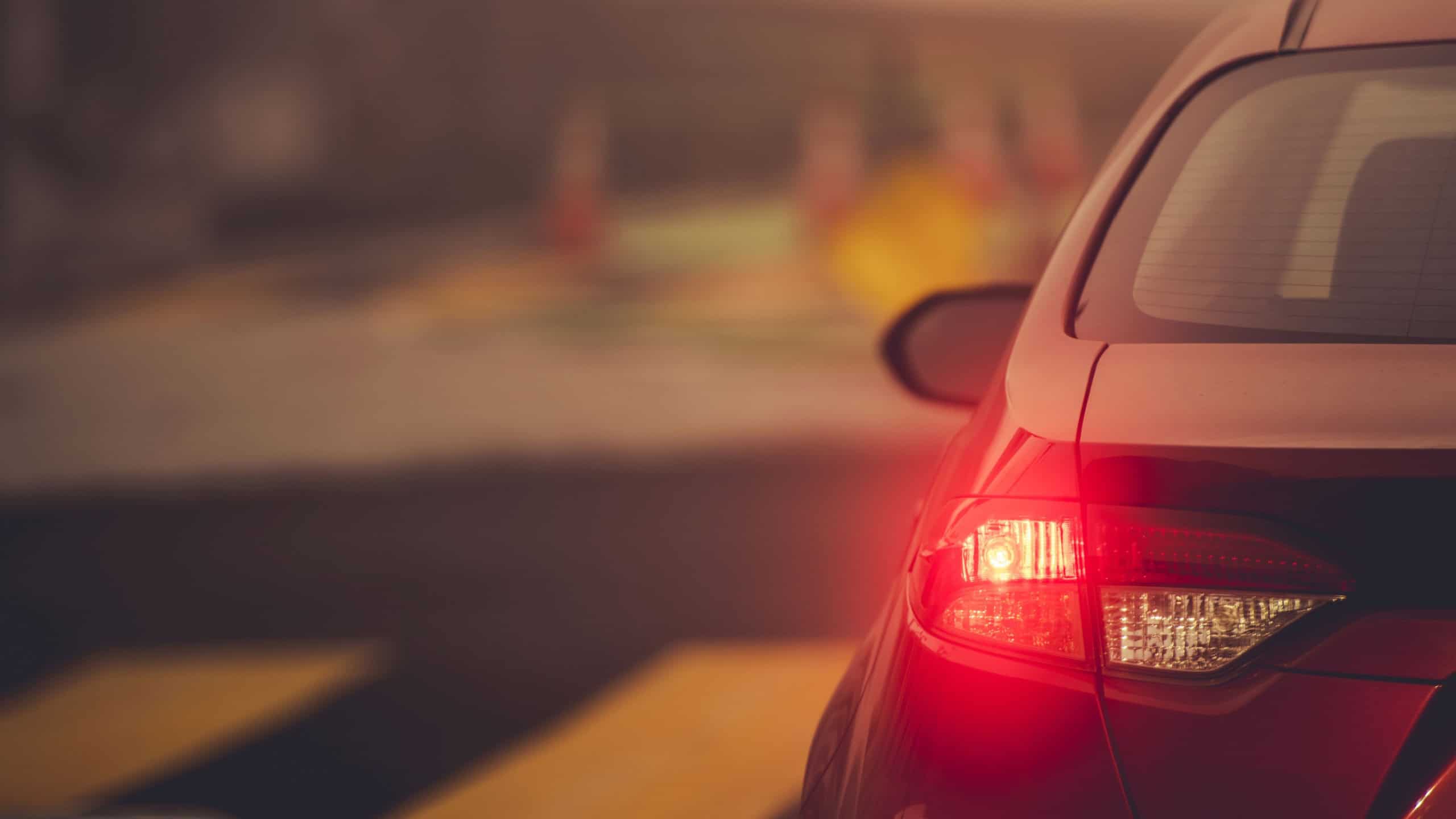 Vehicle Left Turn Signal on a Road Intersection Close Up. Safety Driving Theme.
