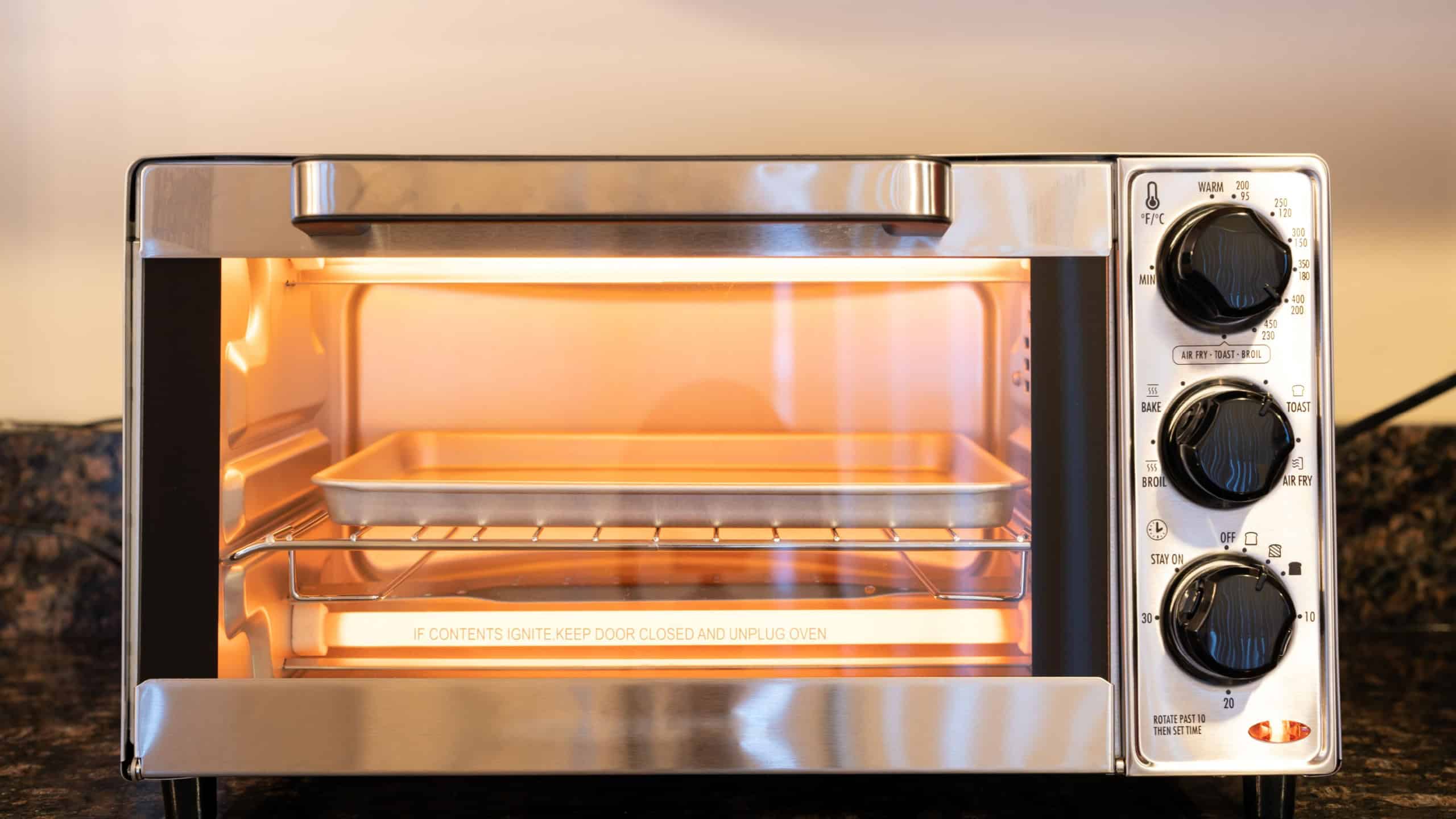 Stainless steel modern design toaster oven is on the granite kitchen countertop