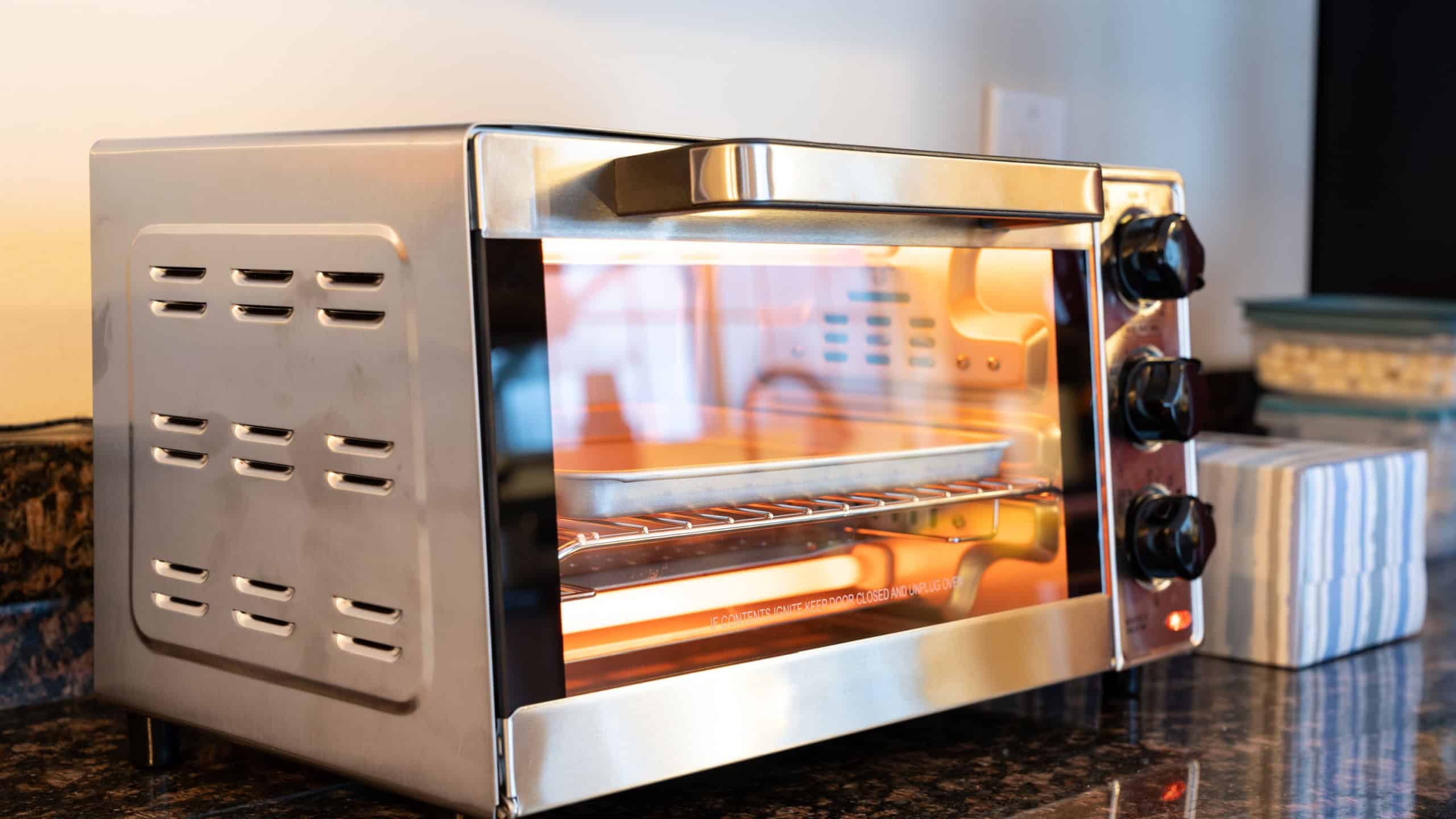 Stainless steel modern design toaster oven is on the granite kitchen countertop
