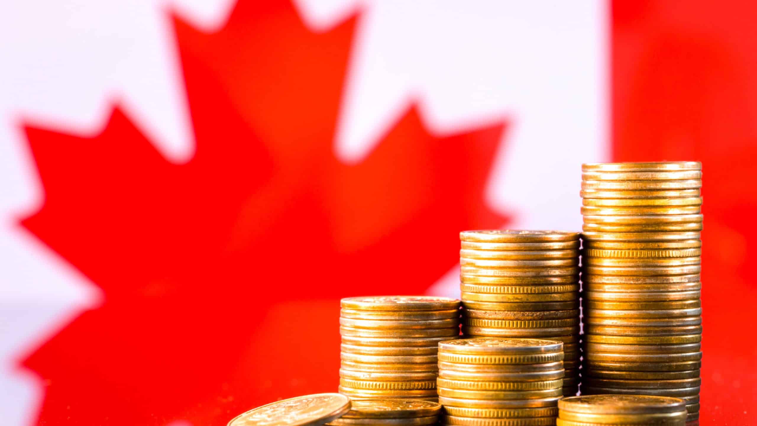 A stack of gold coins on the background of the flag of Canada. Country economy concept