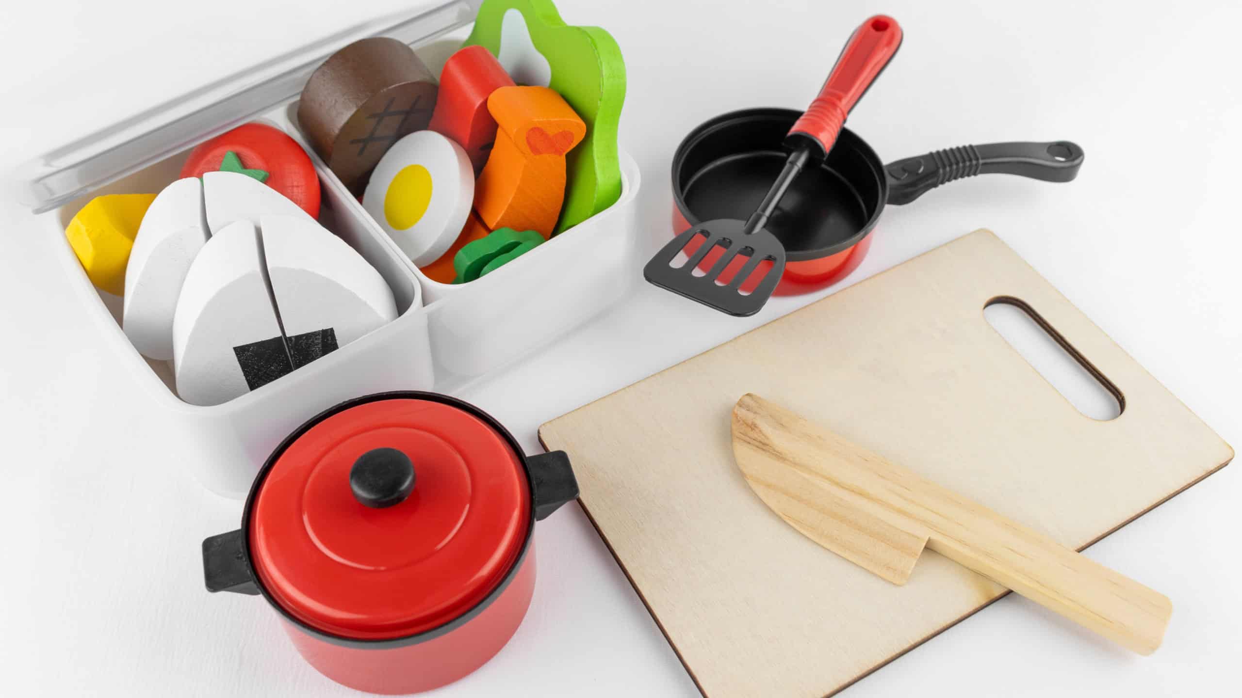 Toy dishes and cooking utensils in a bento box. image of making lunch