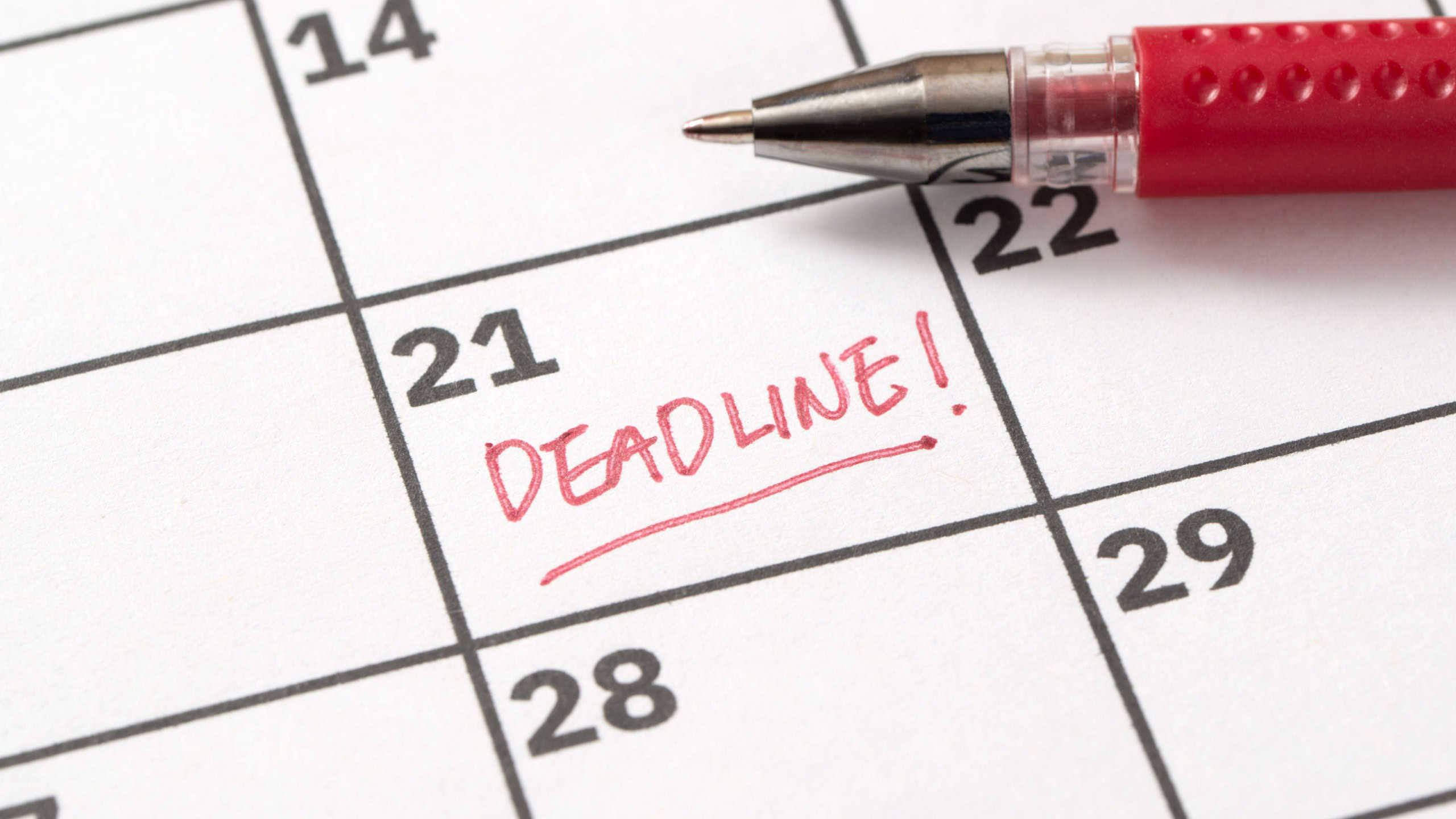 Deadline reminder written on calendar in red marker