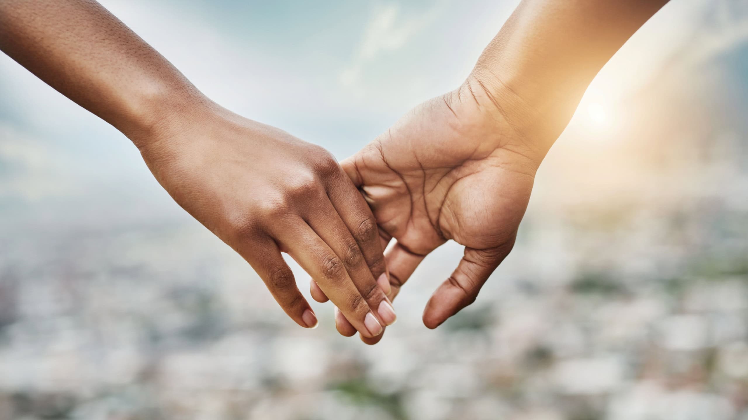 Theres no letting go. Closeup shot of an unrecognizable couple holding hands together outdoors.