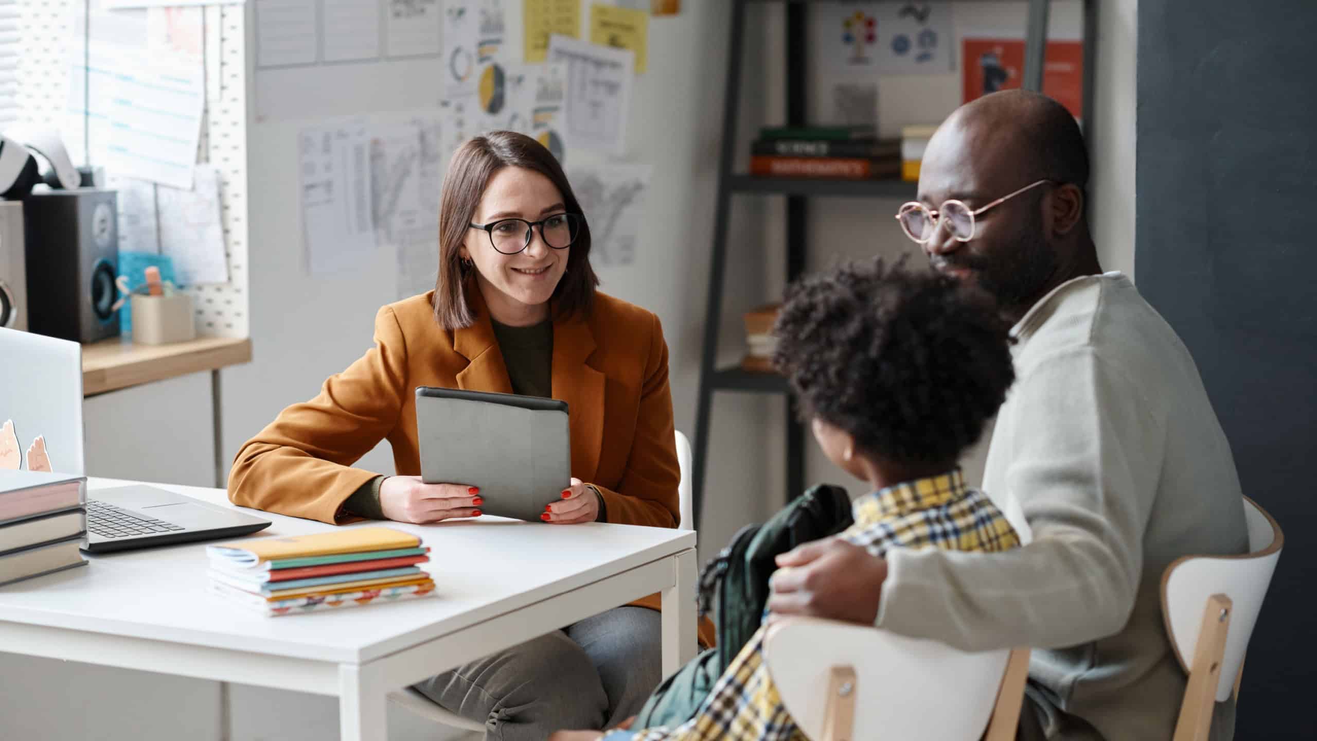 Teacher having meeting with parent of schoolboy