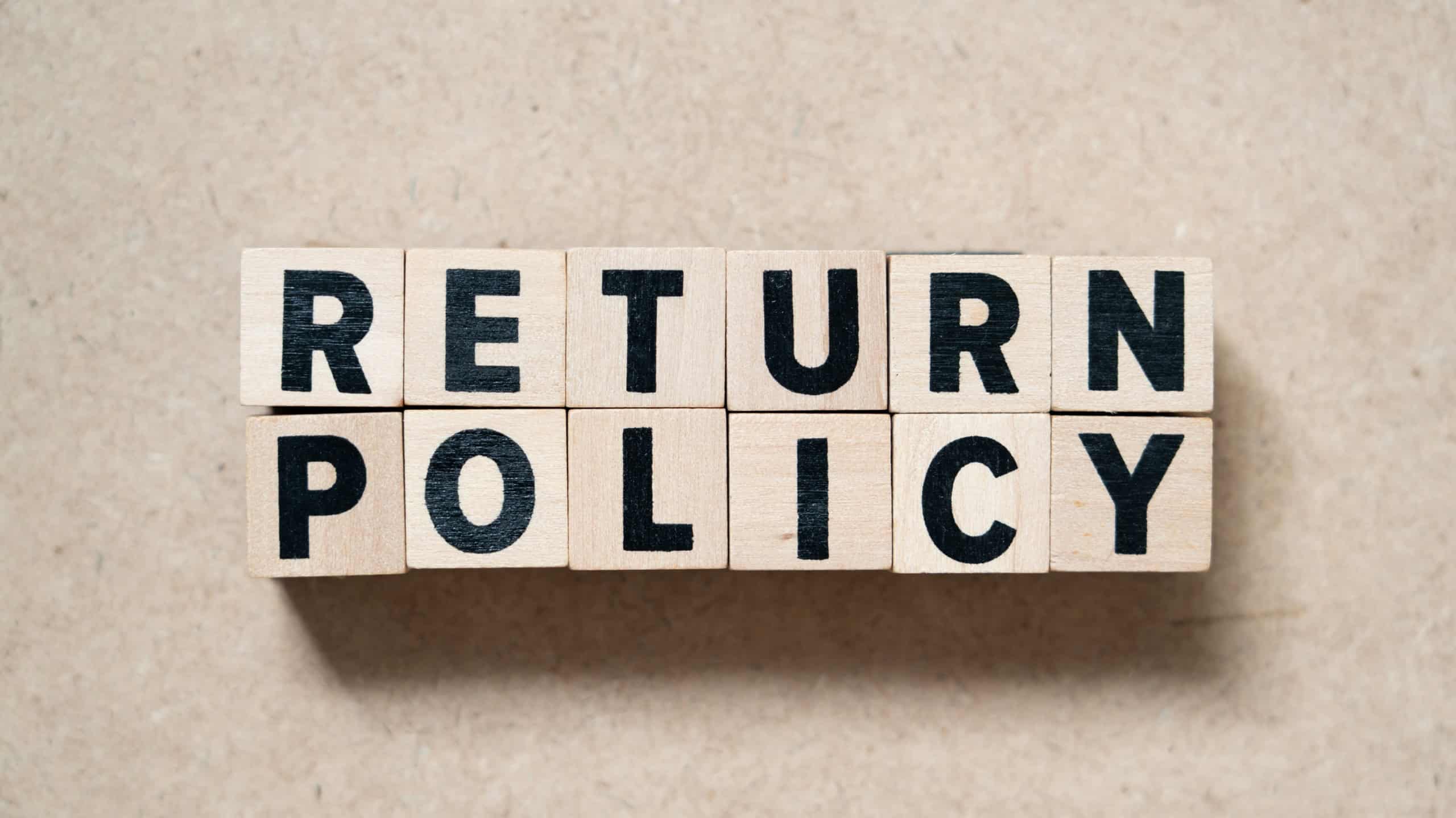 Alphabet letter block in word return policy on wood background